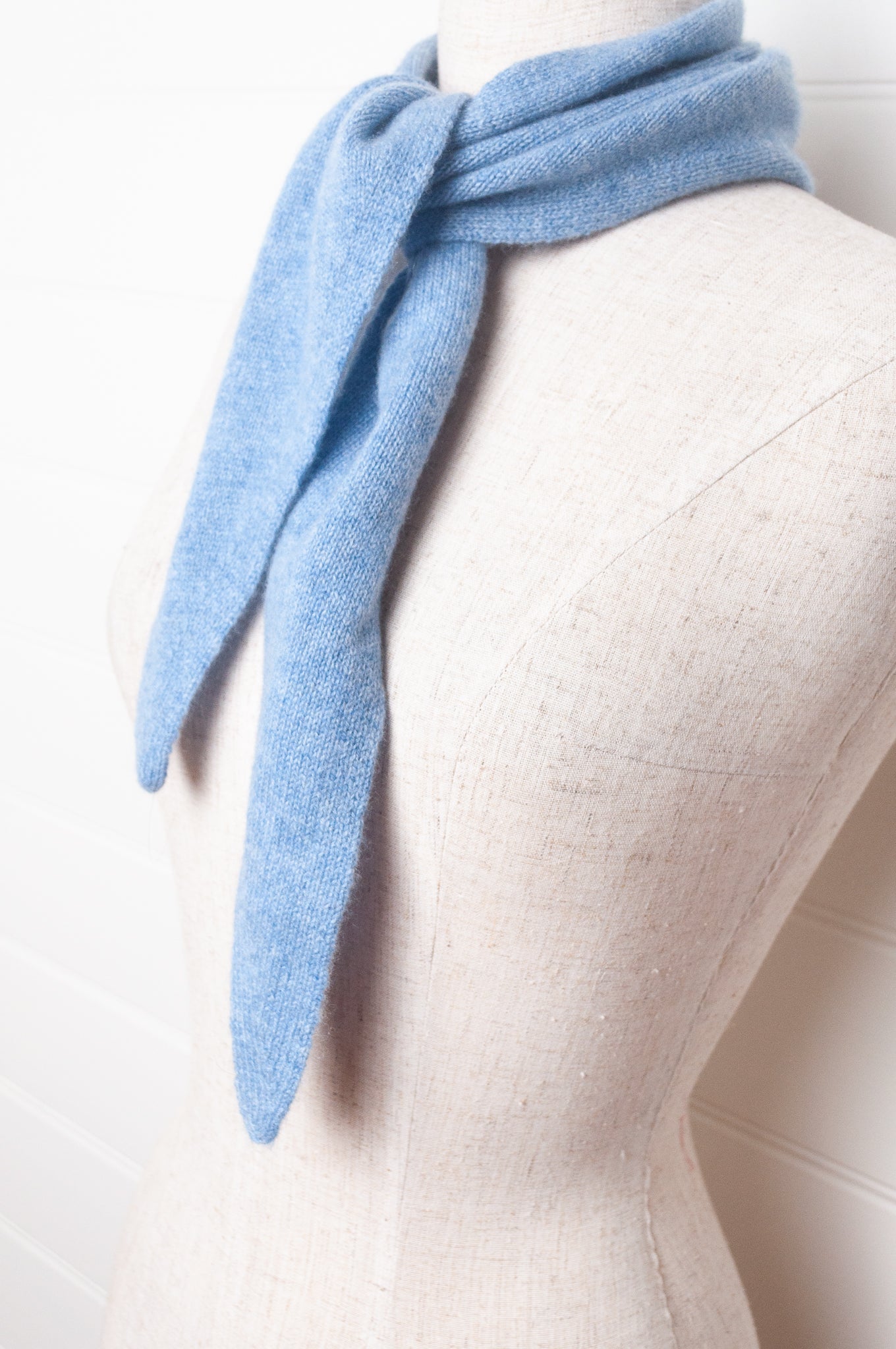 Cashmere triangle neck scarf in sky blue.