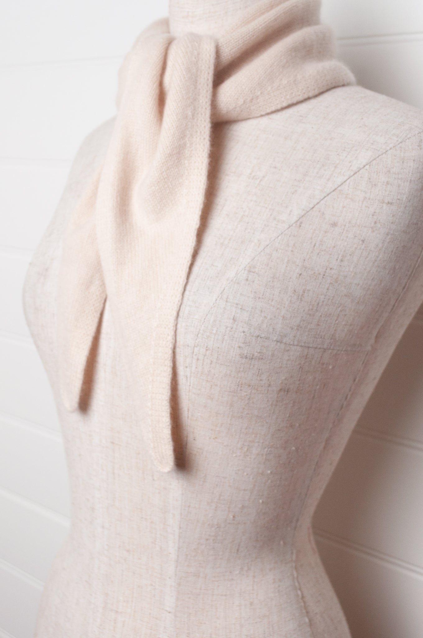 Cashmere triangle neck scarf in ecru cream.