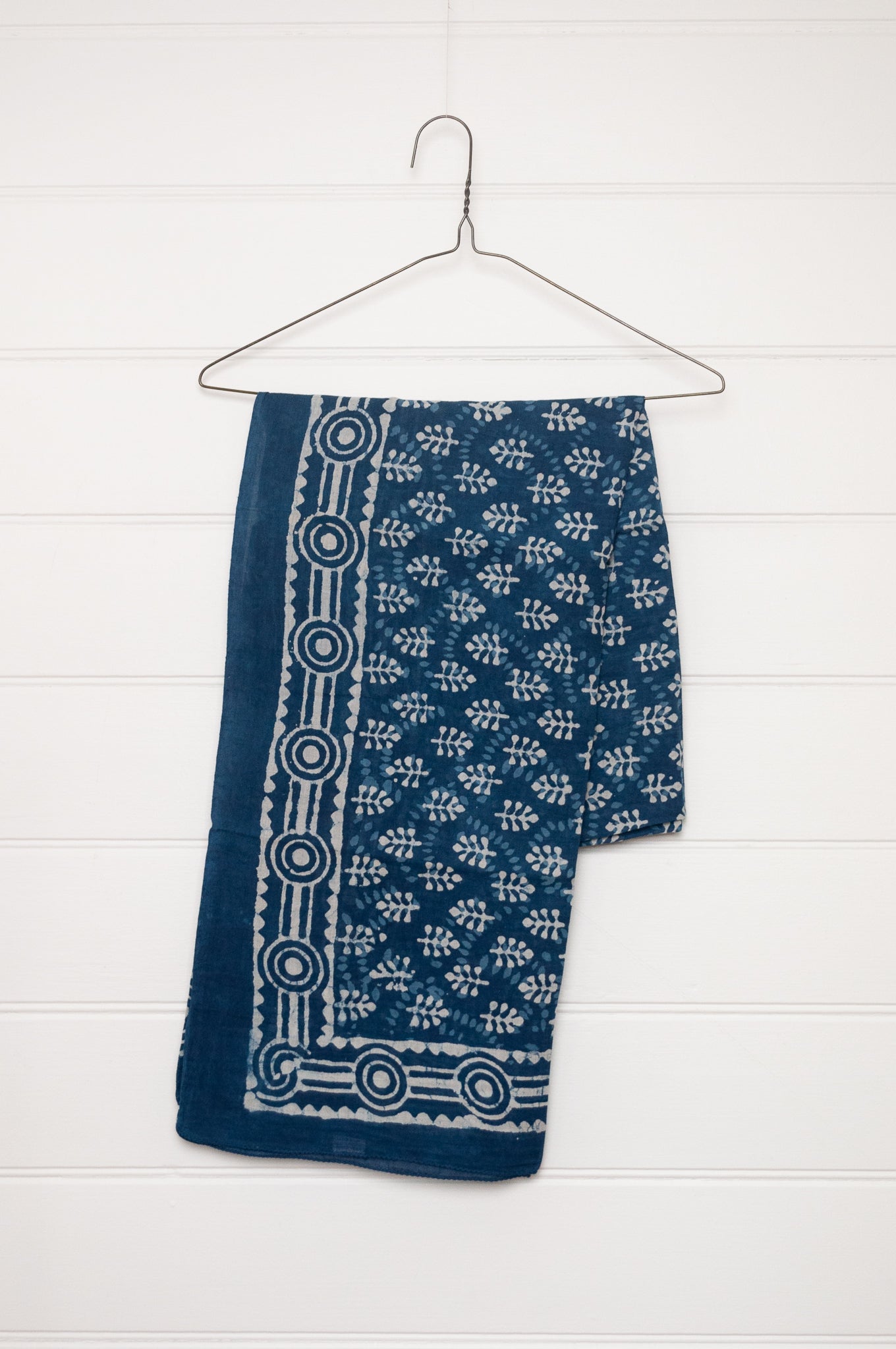 Blue and white indigo blockprint cotton sarong with sprigs and striped border.