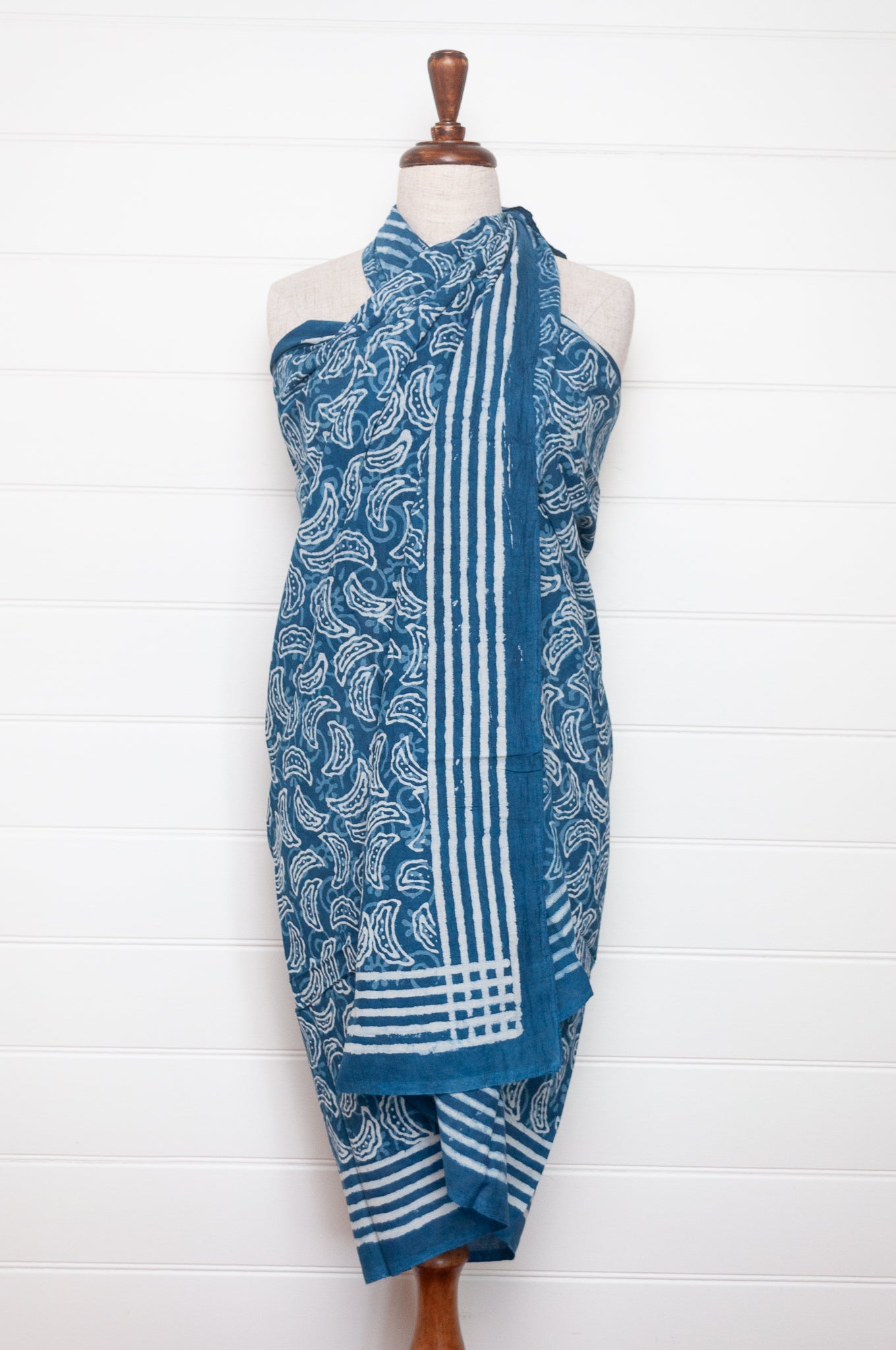 Blue and white indigo blockprint cotton sarong with crescent shapes and striped border.