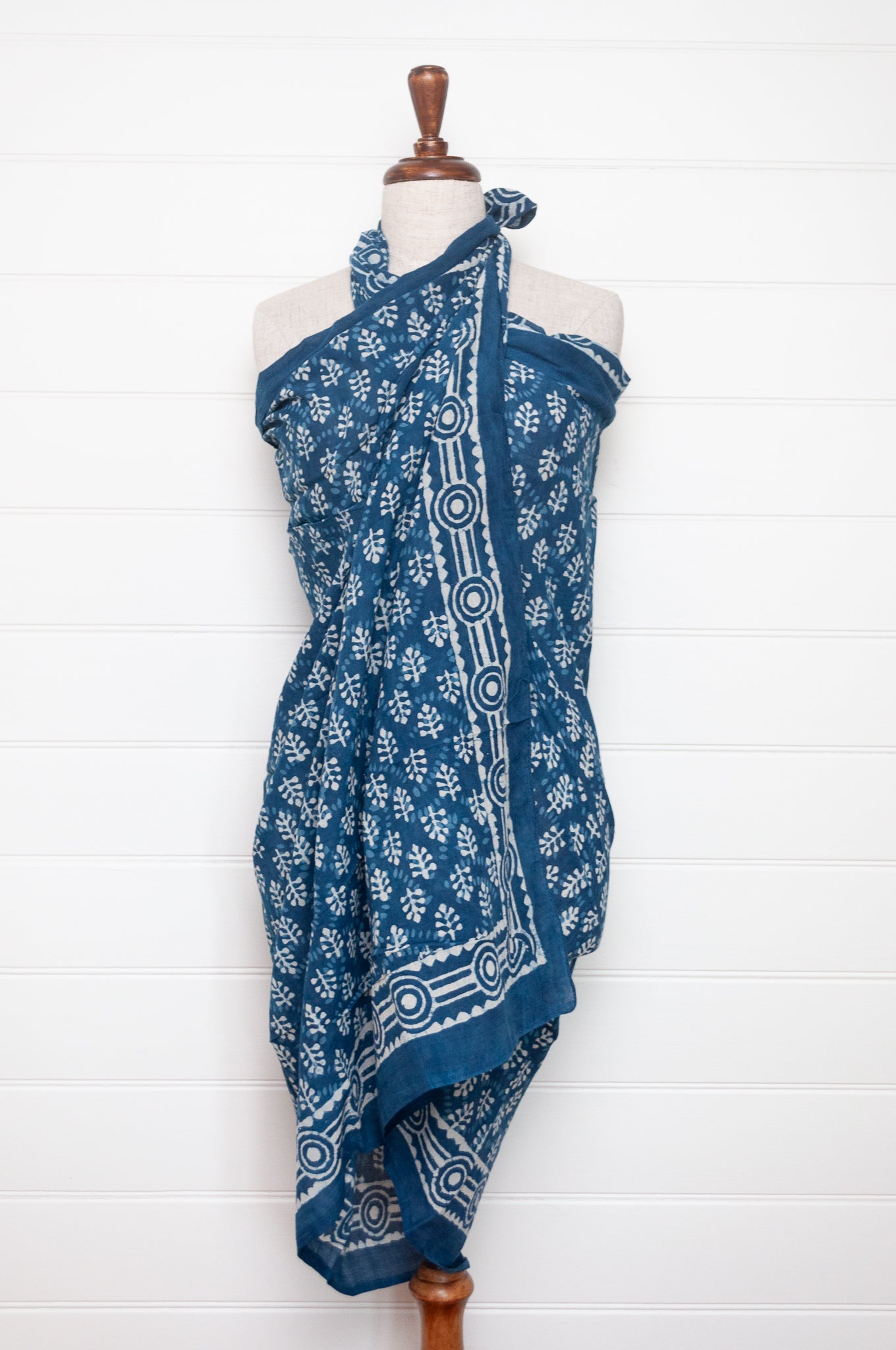 Blue and white indigo blockprint cotton sarong with sprigs and striped border.
