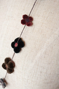 Classic handmade Sophie Digard necklace is a string of beautiful velvet flowers, backed with linen embroidery in a cool winter palette, Dingle.