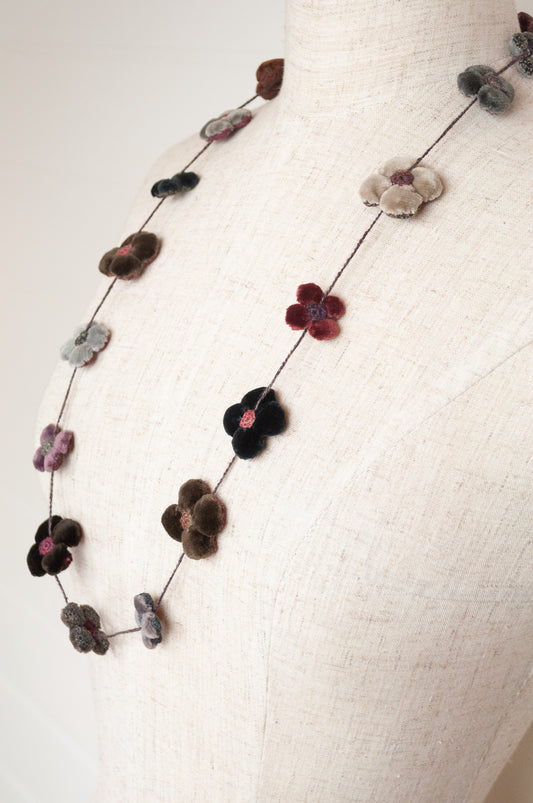 Classic handmade Sophie Digard necklace is a string of beautiful velvet flowers, backed with linen embroidery in a cool winter palette, Dingle.