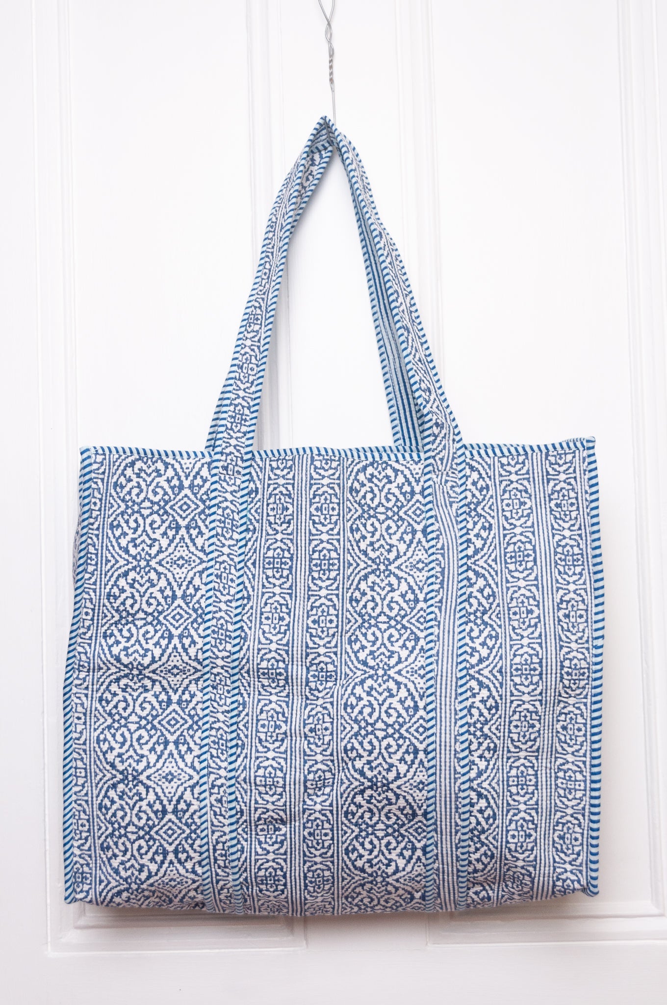 Blue and white quilted tote bag.