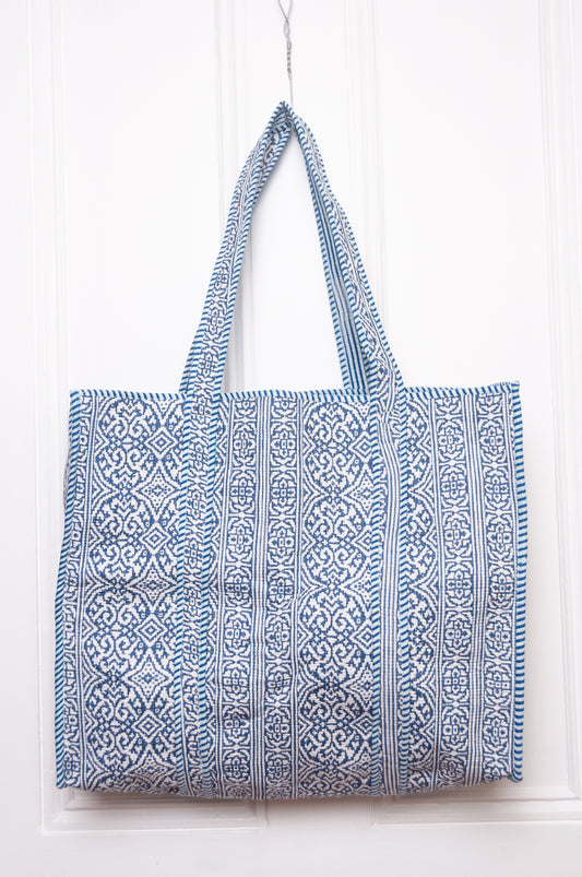 Blue and white quilted tote bag.