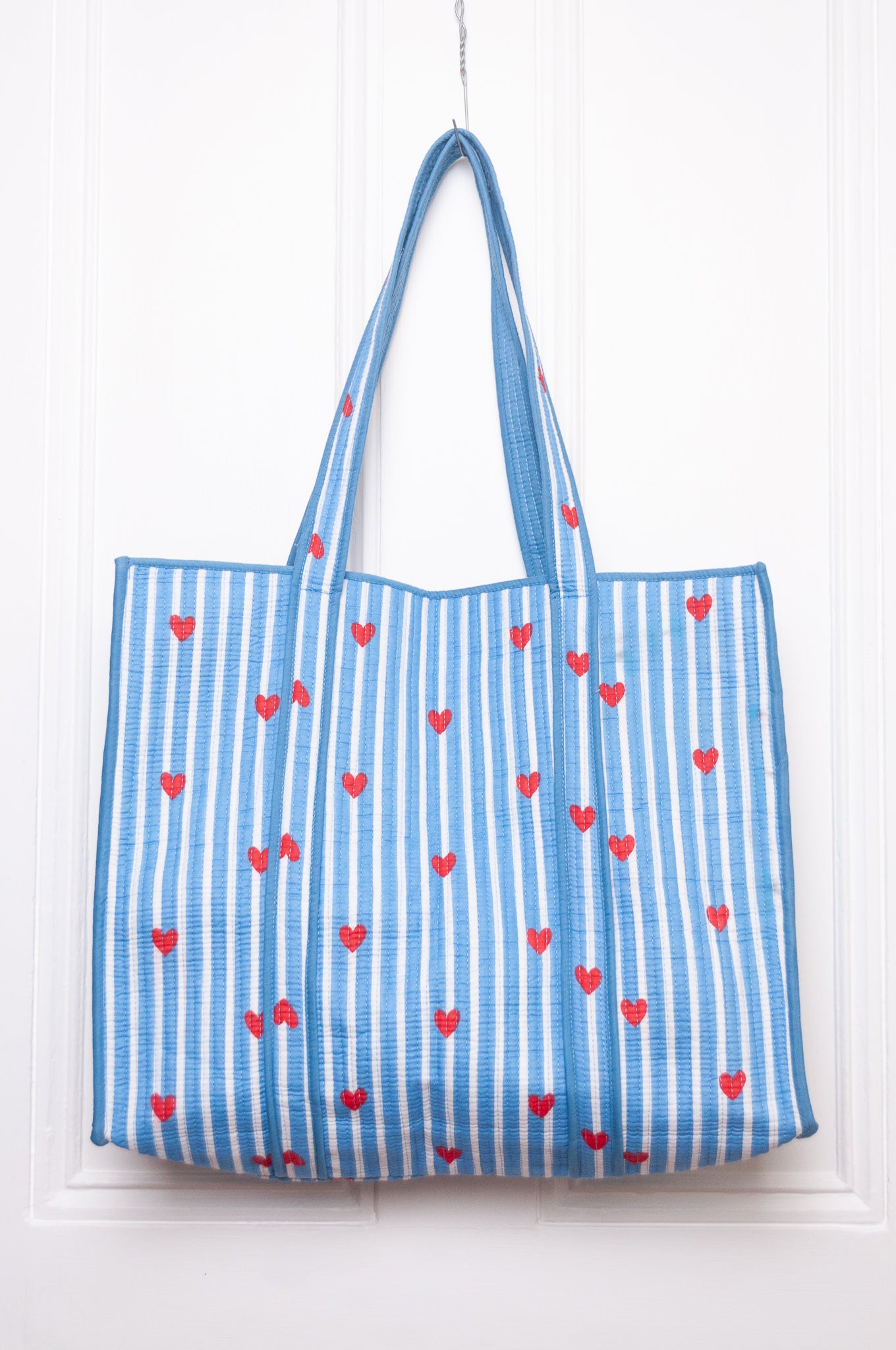Blue and white striped with red hearts quilted tote bag.