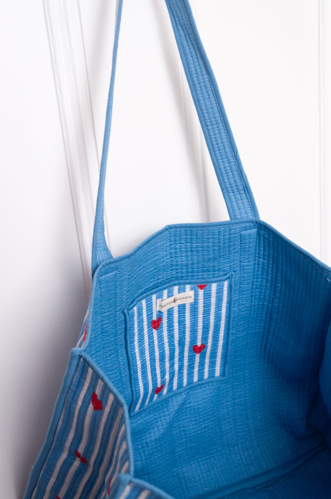 Blue and white striped with red hearts quilted tote bag.