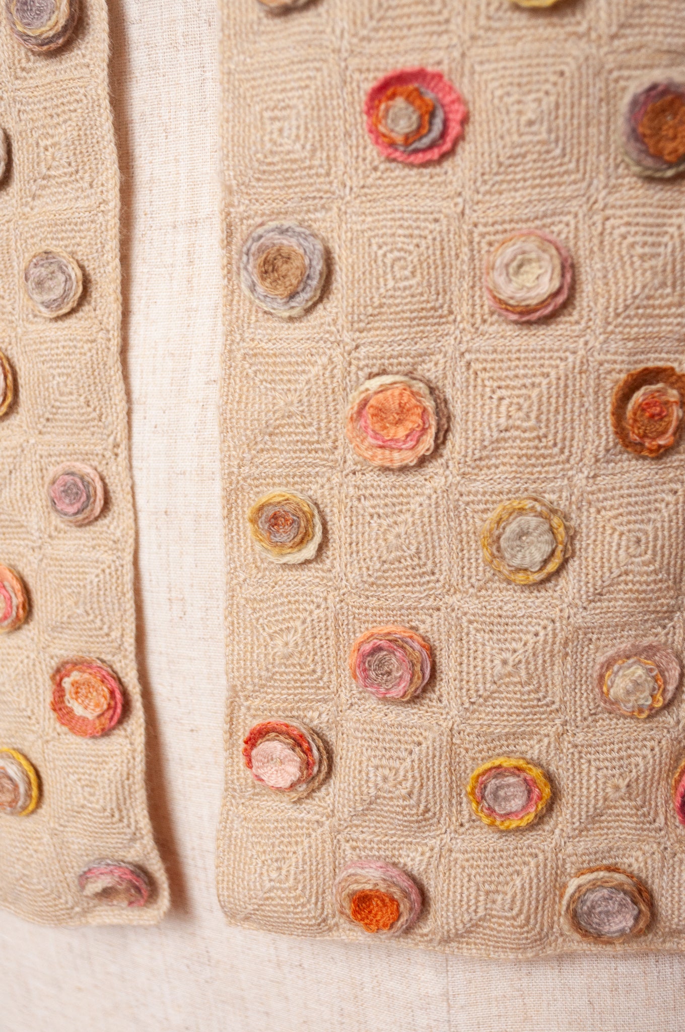 Sophie Digard crocehted scarf with warm toned small crocehted flower medallions on a neutral base.