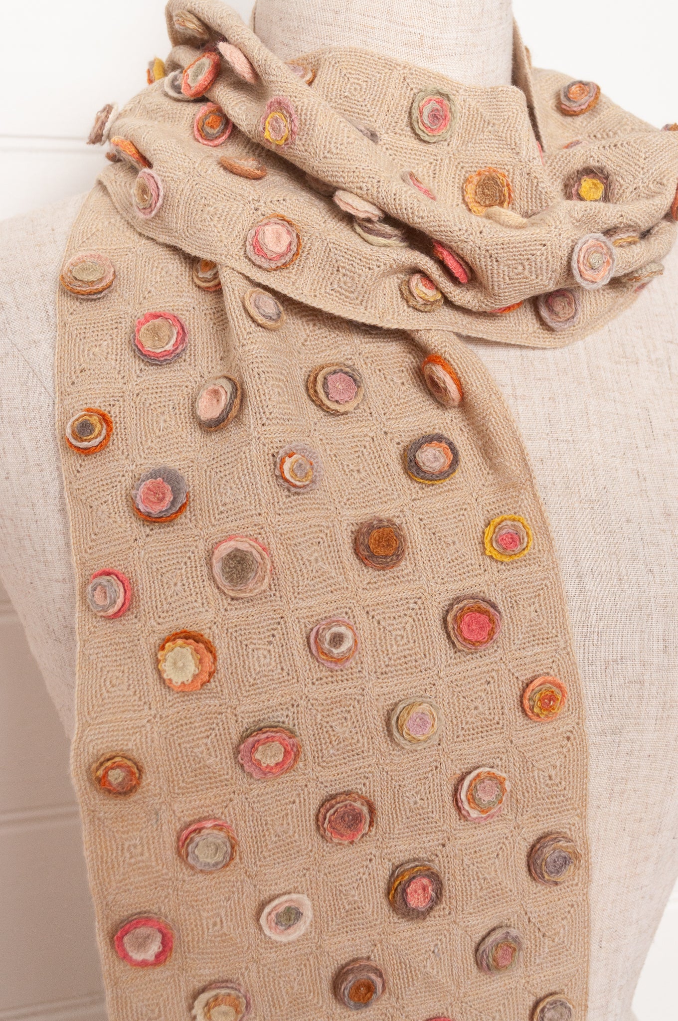 Sophie Digard crocehted scarf with warm toned small crocehted flower medallions on a neutral base.