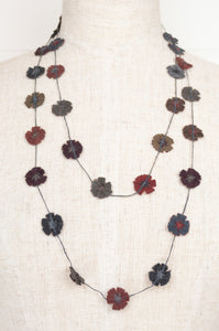 Classic handmade Sophie Digard necklace is a string of embroidered wool flowers, in a cool winter palette, Dingle.