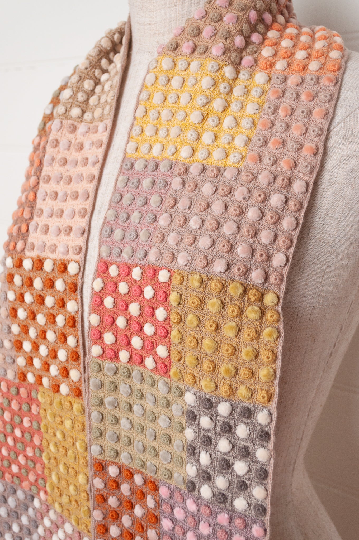 Sophie Digard crocehted scarf in warm tones, patchwork squares with small velvet spots.