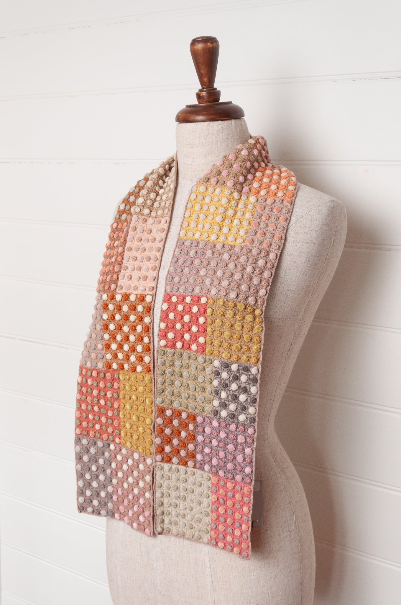 Sophie Digard crocehted scarf in warm tones, patchwork squares with small velvet spots.