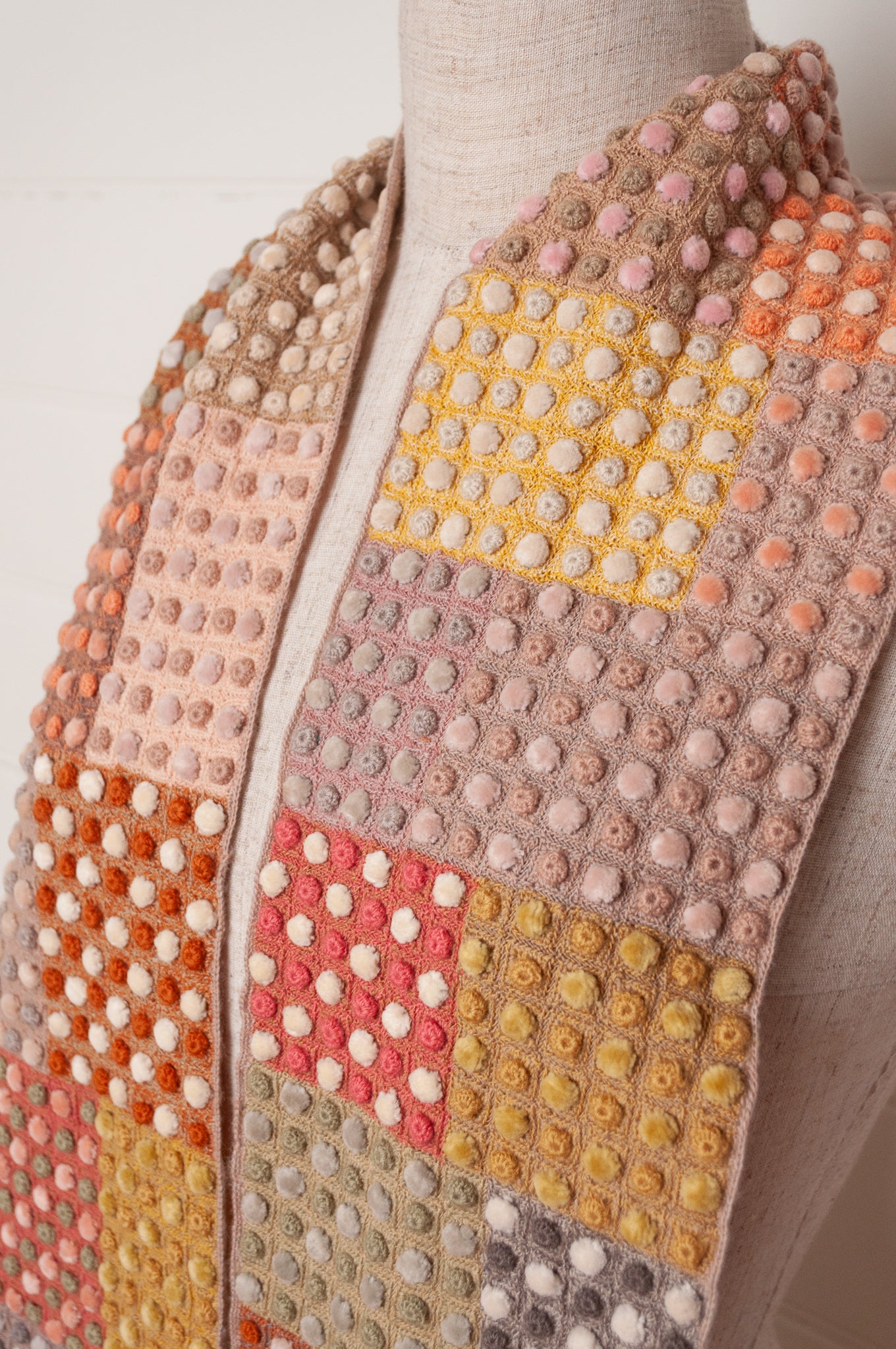 Sophie Digard crocehted scarf in warm tones, patchwork squares with small velvet spots.