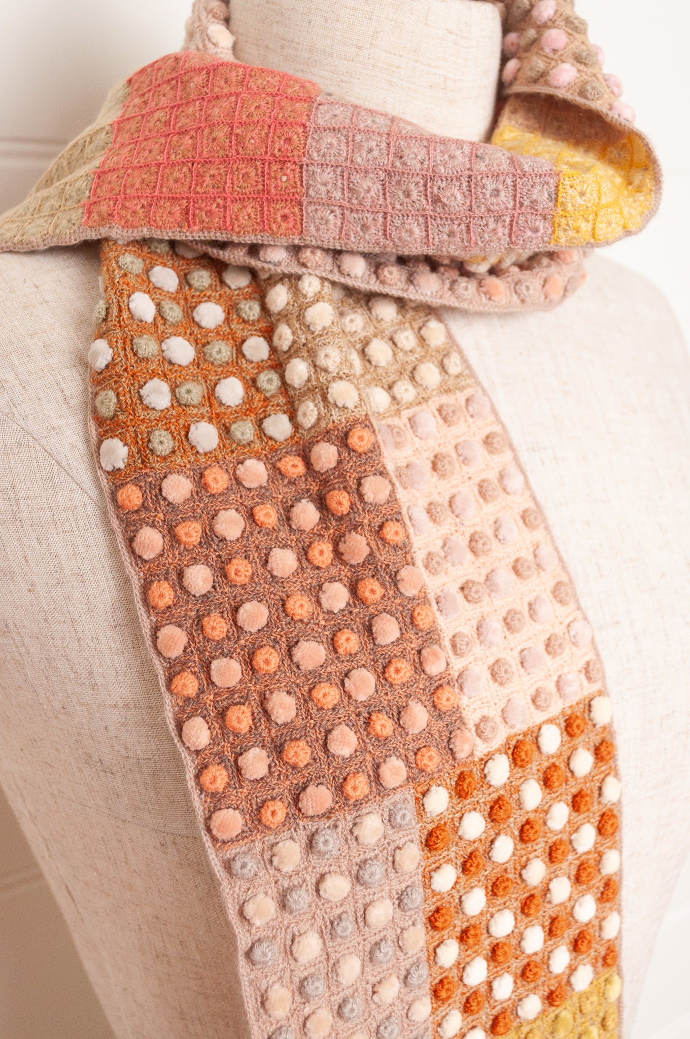 Sophie Digard crocehted scarf in warm tones, patchwork squares with small velvet spots.