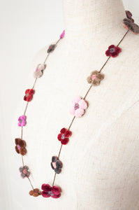 classic Sophie Digard handmade embroidered necklace is a string of beautiful velvet flowers, backed with linen embroidery in shades of rose pink, crimson, chocolate and taupe.