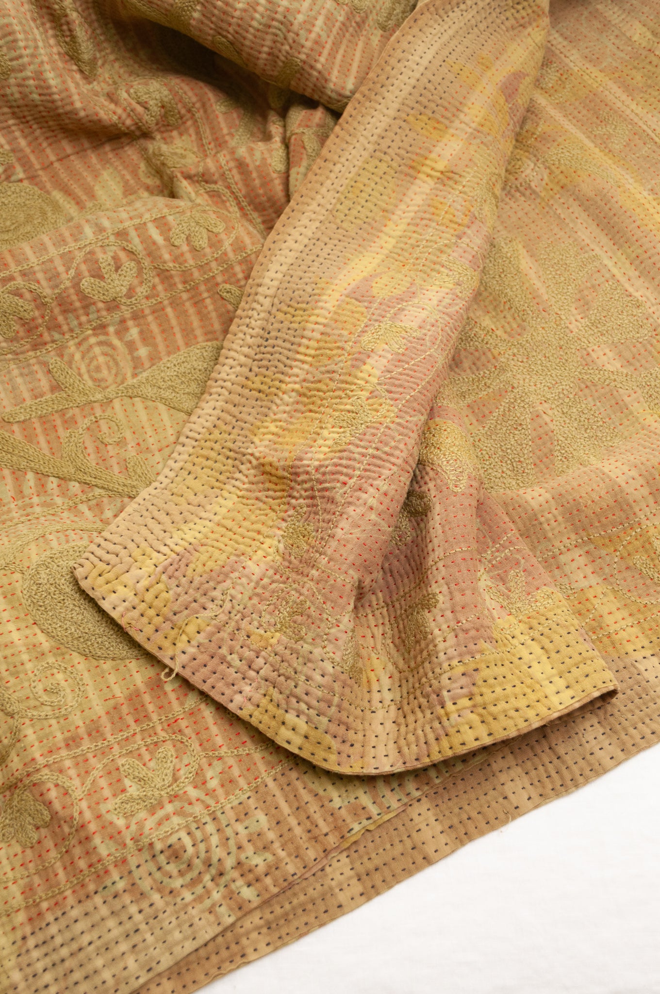 Vintage kantha quilt embroidered Suzani style floral design in olive on mustard stripes.