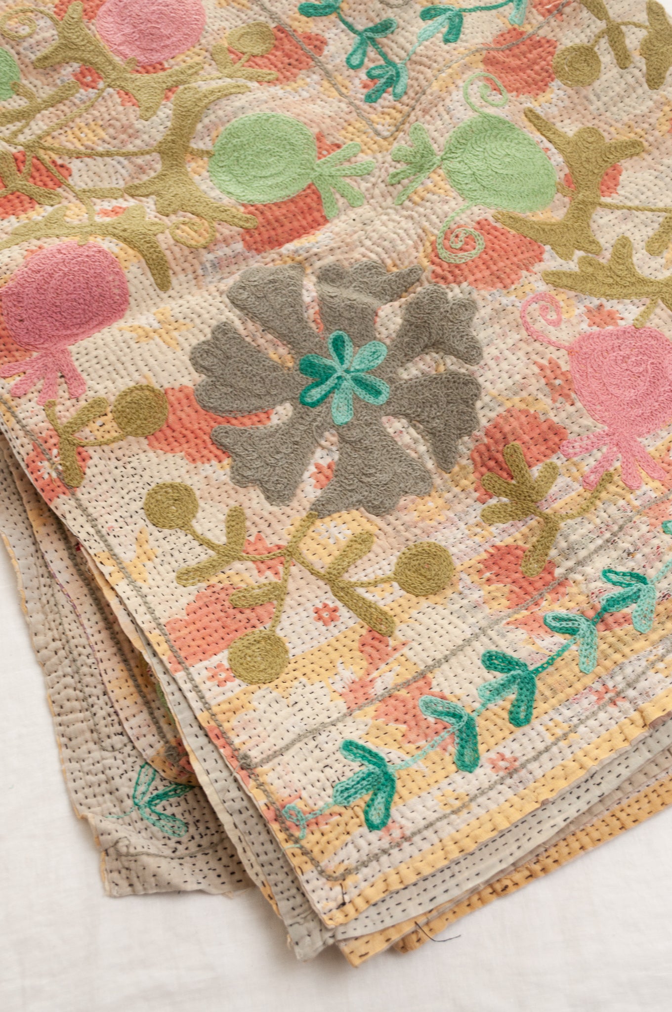 Suzani embroidered vintage kantha quilt floral design in pink, teal, aqua and mustard.