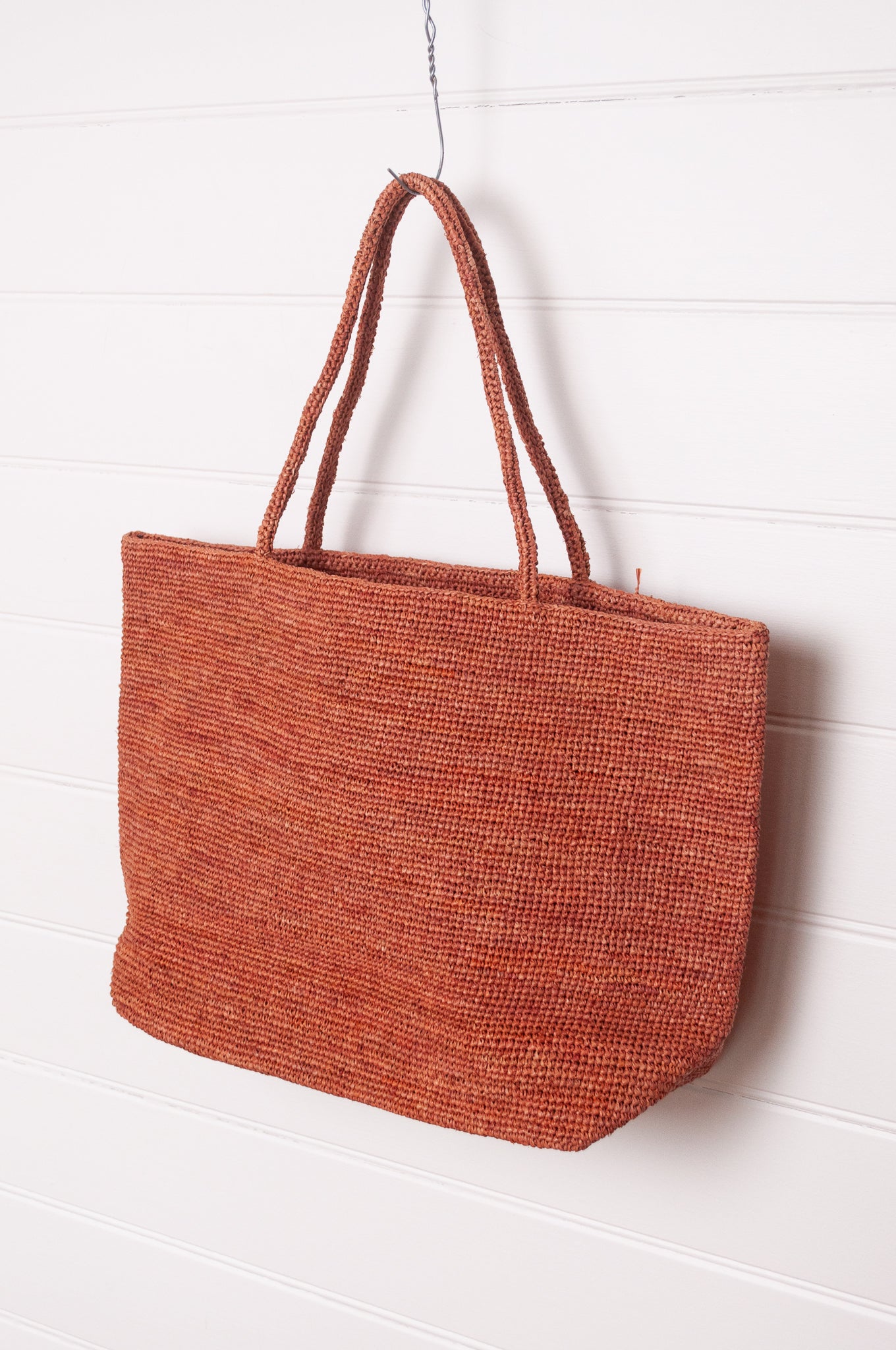 Sophie Digard large crochet raffia bag in ember rust brown.
