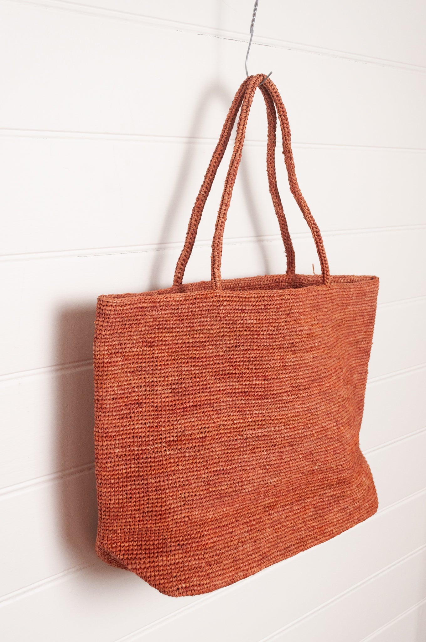 Sophie Digard large crochet raffia bag in ember rust brown.