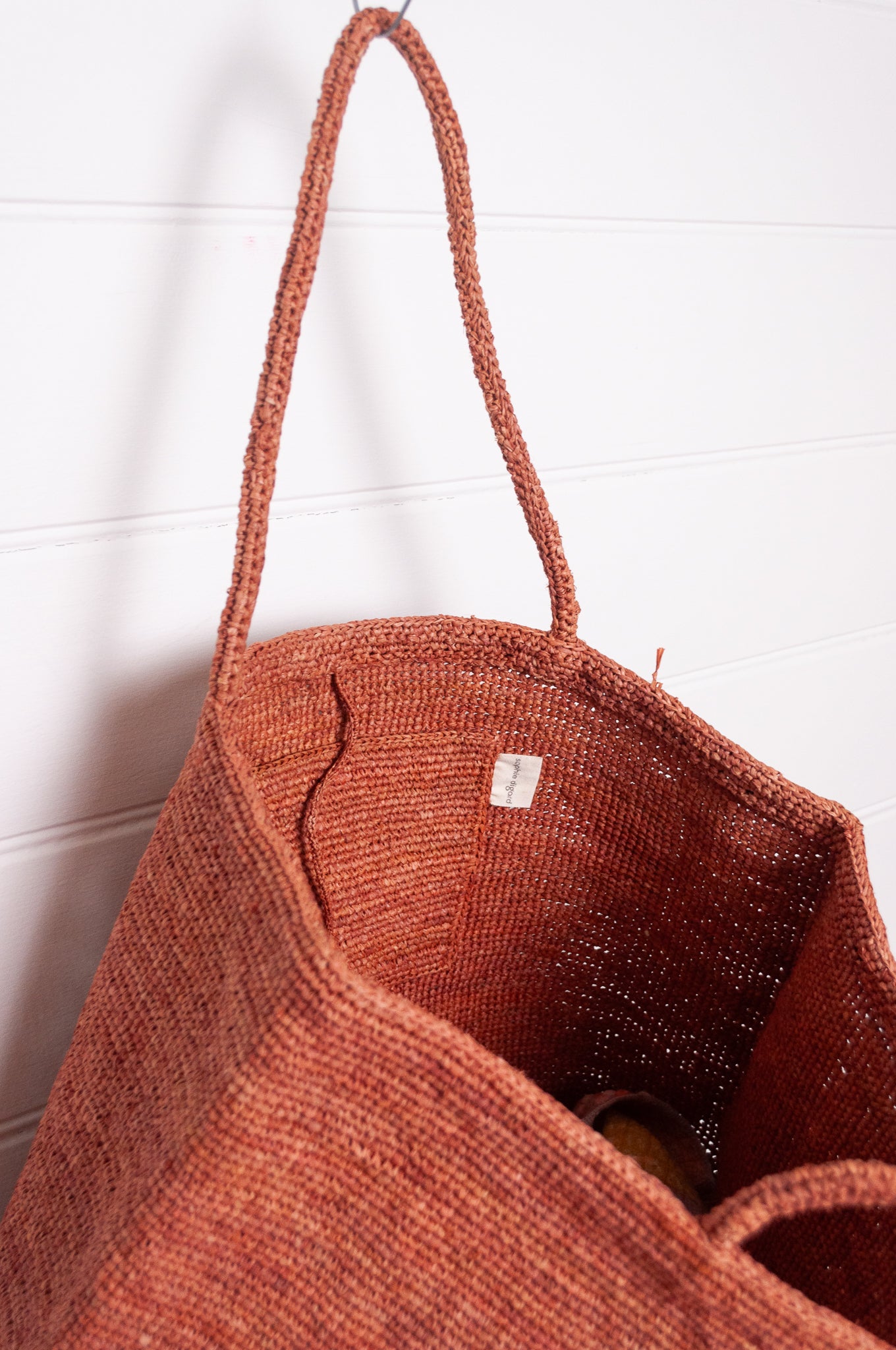Sophie Digard large crochet raffia bag in ember rust brown.