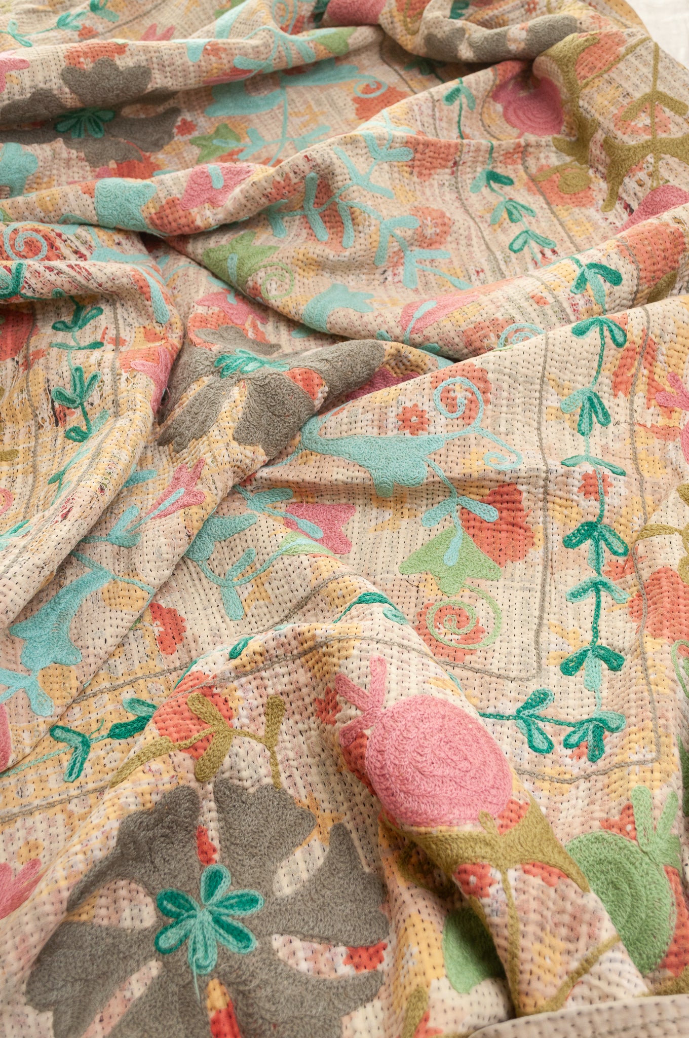 Suzani embroidered vintage kantha quilt floral design in pink, teal, aqua and mustard.