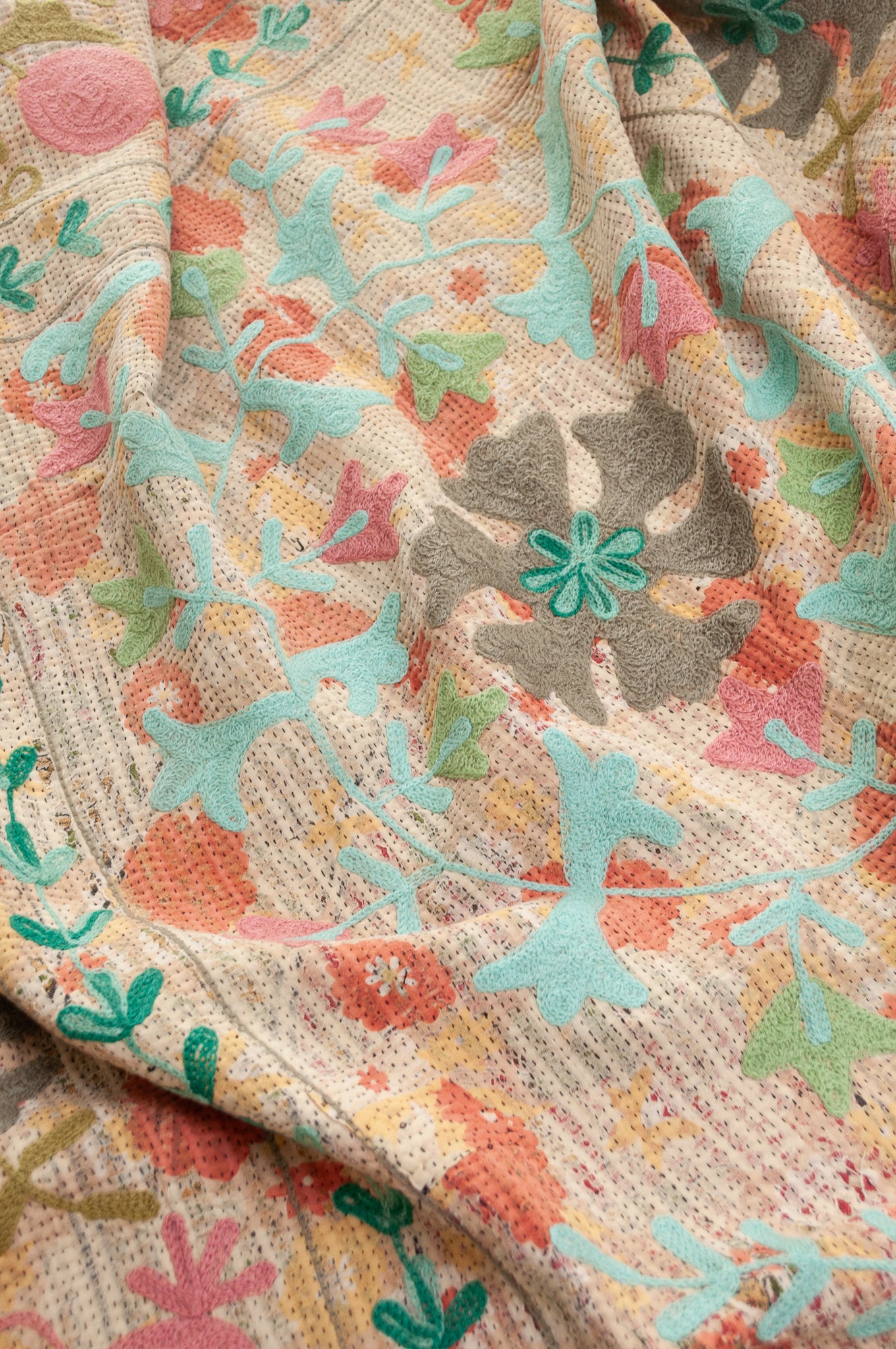 Suzani embroidered vintage kantha quilt floral design in pink, teal, aqua and mustard.
