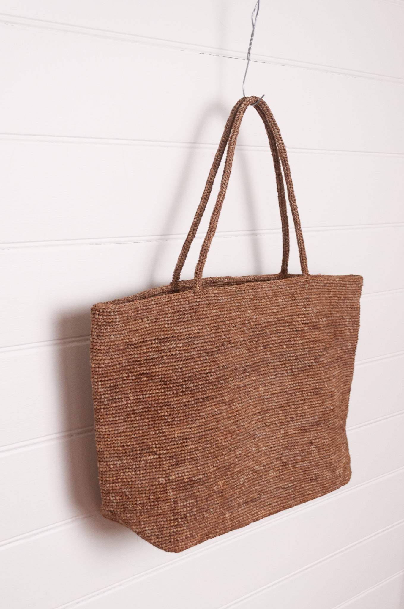 Sophie Digard large crochet raffia bag in terre d'ombre umber brown.