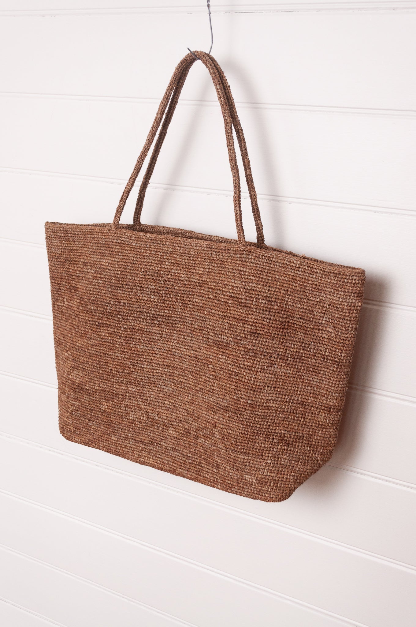 Sophie Digard large crochet raffia bag in terre d'ombre umber brown.