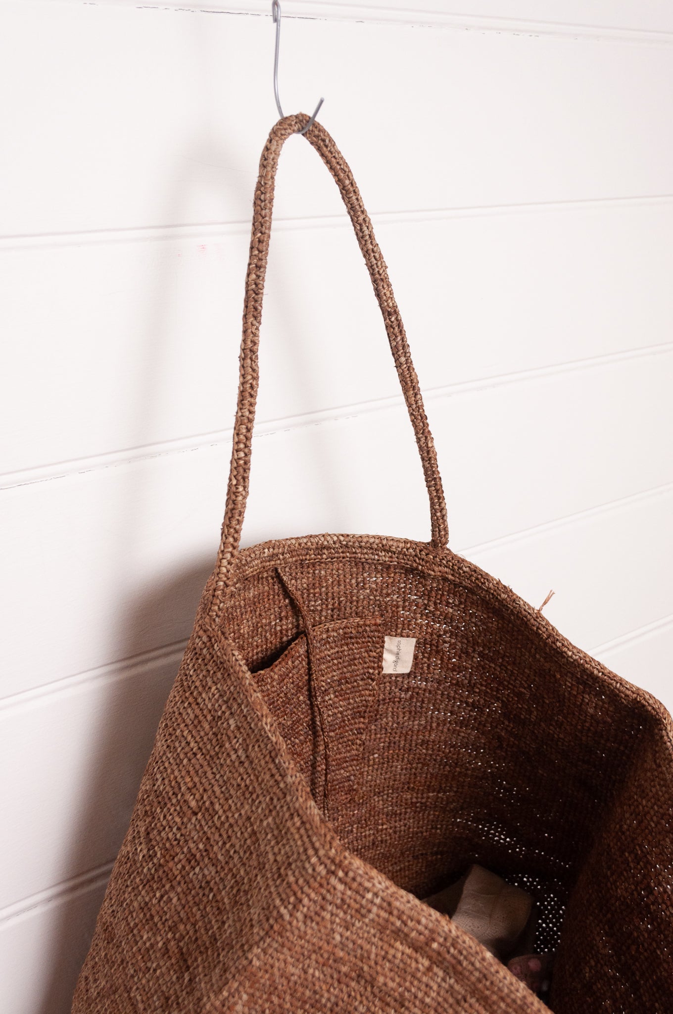 Sophie Digard large crochet raffia bag in terre d'ombre umber brown.