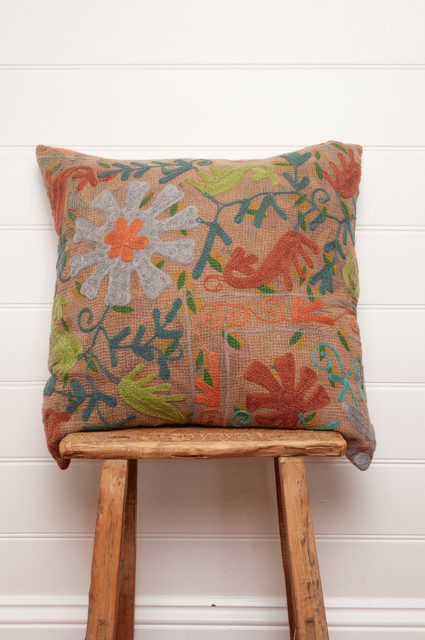 Suzani embroidered vintage kantha quilt cushion silver blue, lime, teal and rust floral on coffee brown background.