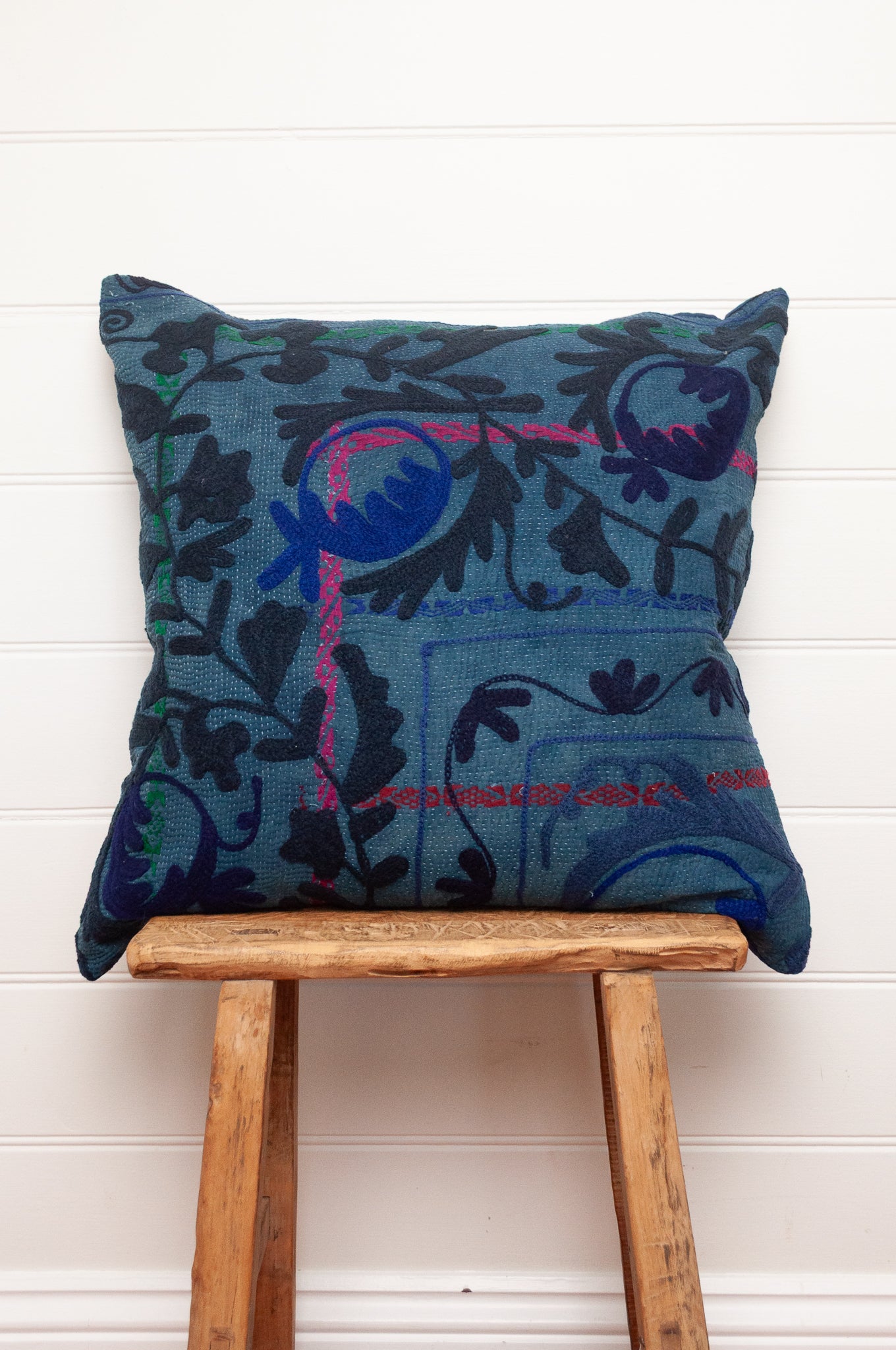 Suzani embroidered vintage indigo kantha quilt cushion, floral design in deep indigo and cobalt blue on mid blue.