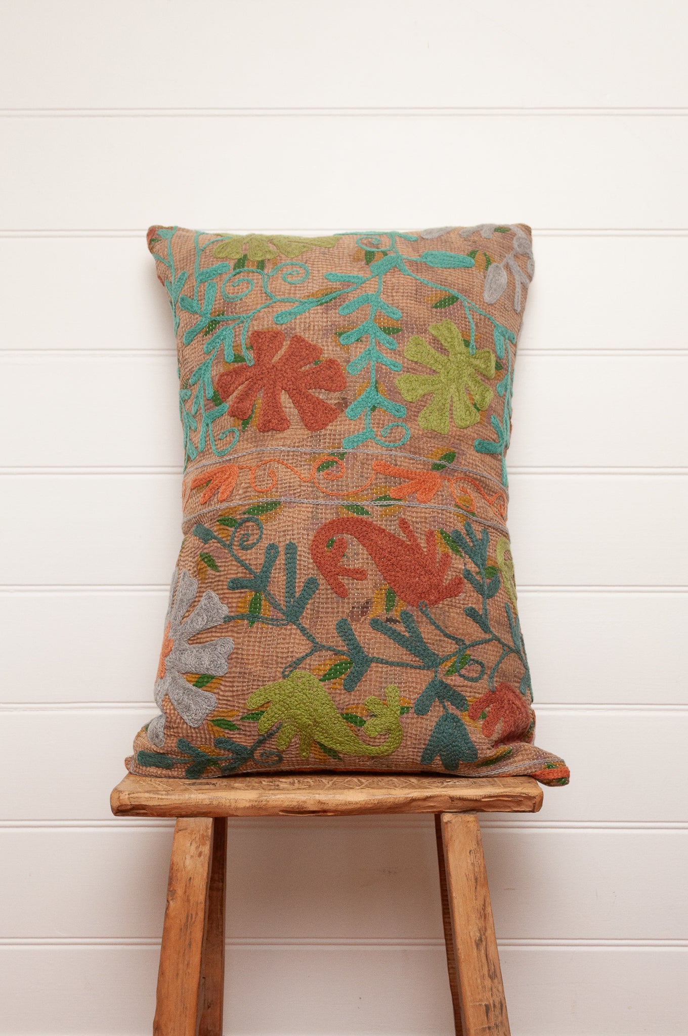 Suzani embroidered vintage kantha quilt cushion, floral design aqua, lime, rust and teal on sepia brown base.
