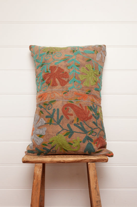 Suzani embroidered vintage kantha quilt cushion, floral design aqua, lime, rust and teal on sepia brown base.