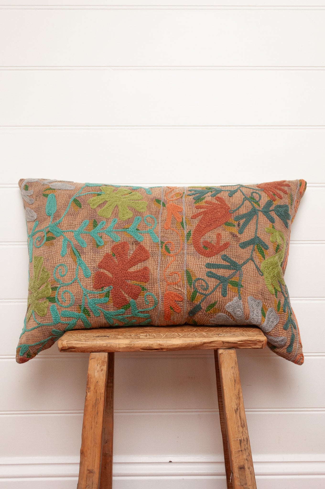 Suzani embroidered vintage kantha quilt cushion, floral design aqua, lime, rust and teal on sepia brown base.