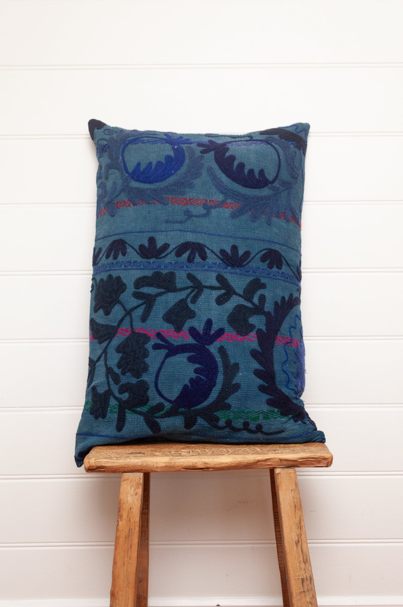 Suzani embroidered vintage indigo quilt, floral design in deep indigo and cobalt blue on indigo base with red highlights.