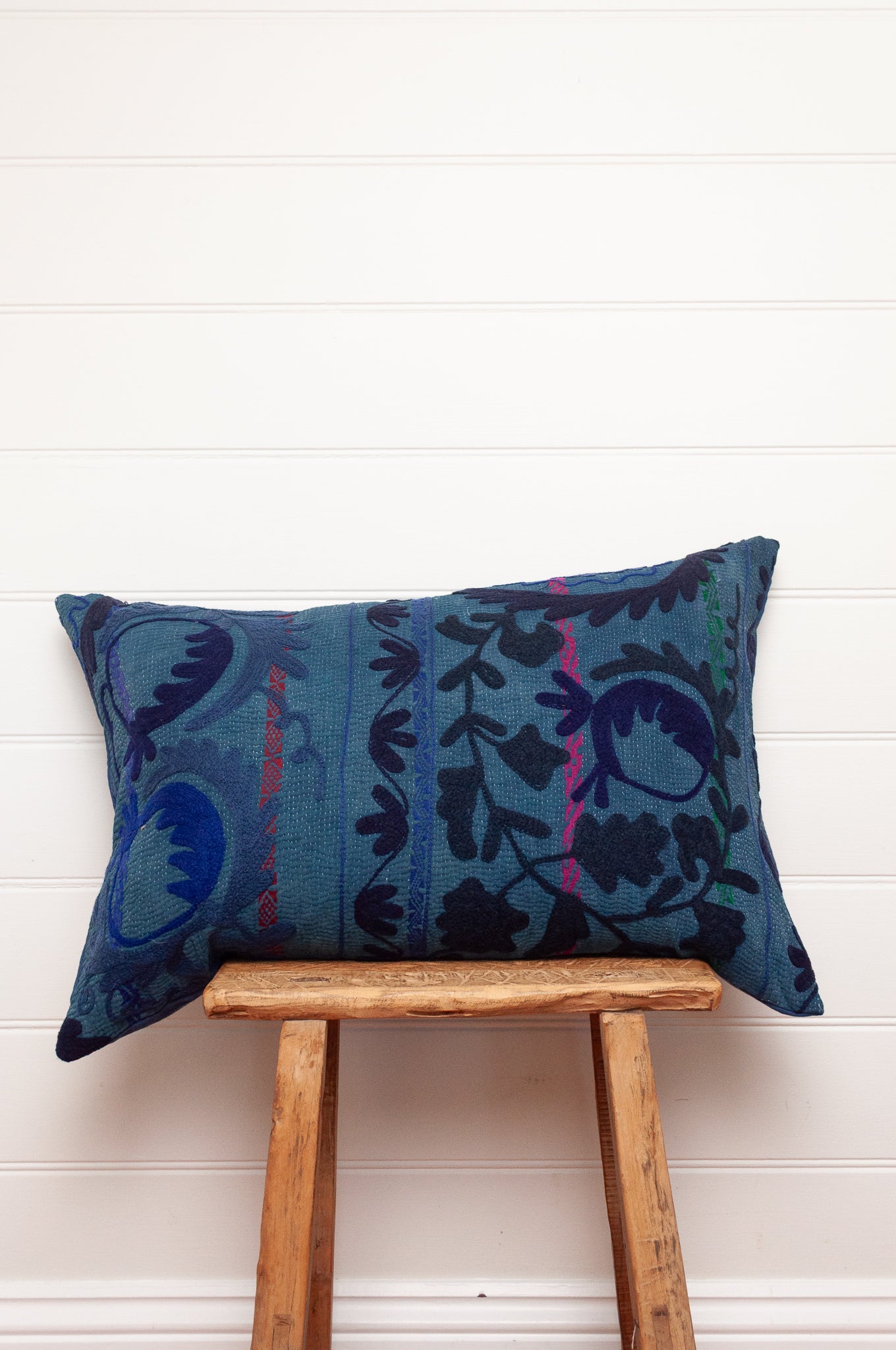 Suzani embroidered vintage indigo quilt, floral design in deep indigo and cobalt blue on indigo base with red highlights.