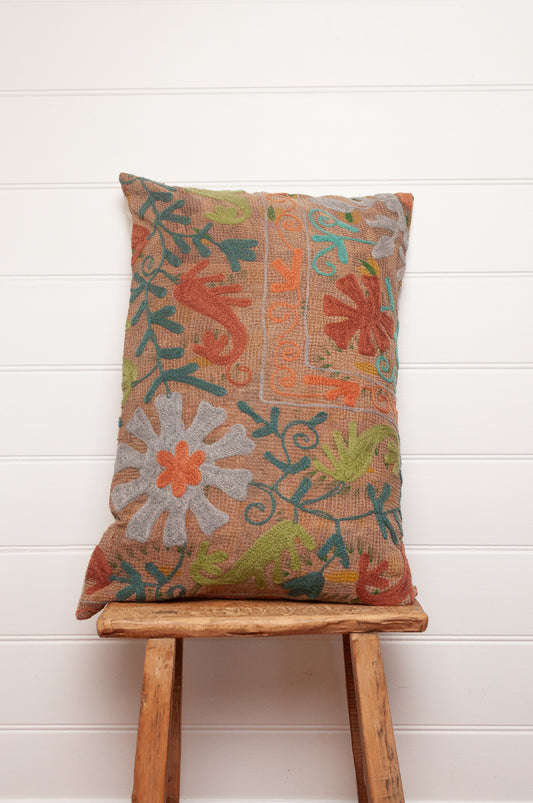 Suzani embroidered vintage kantha quilt cushion, floral design aqua, lime, rust and teal on sepia brown base.
