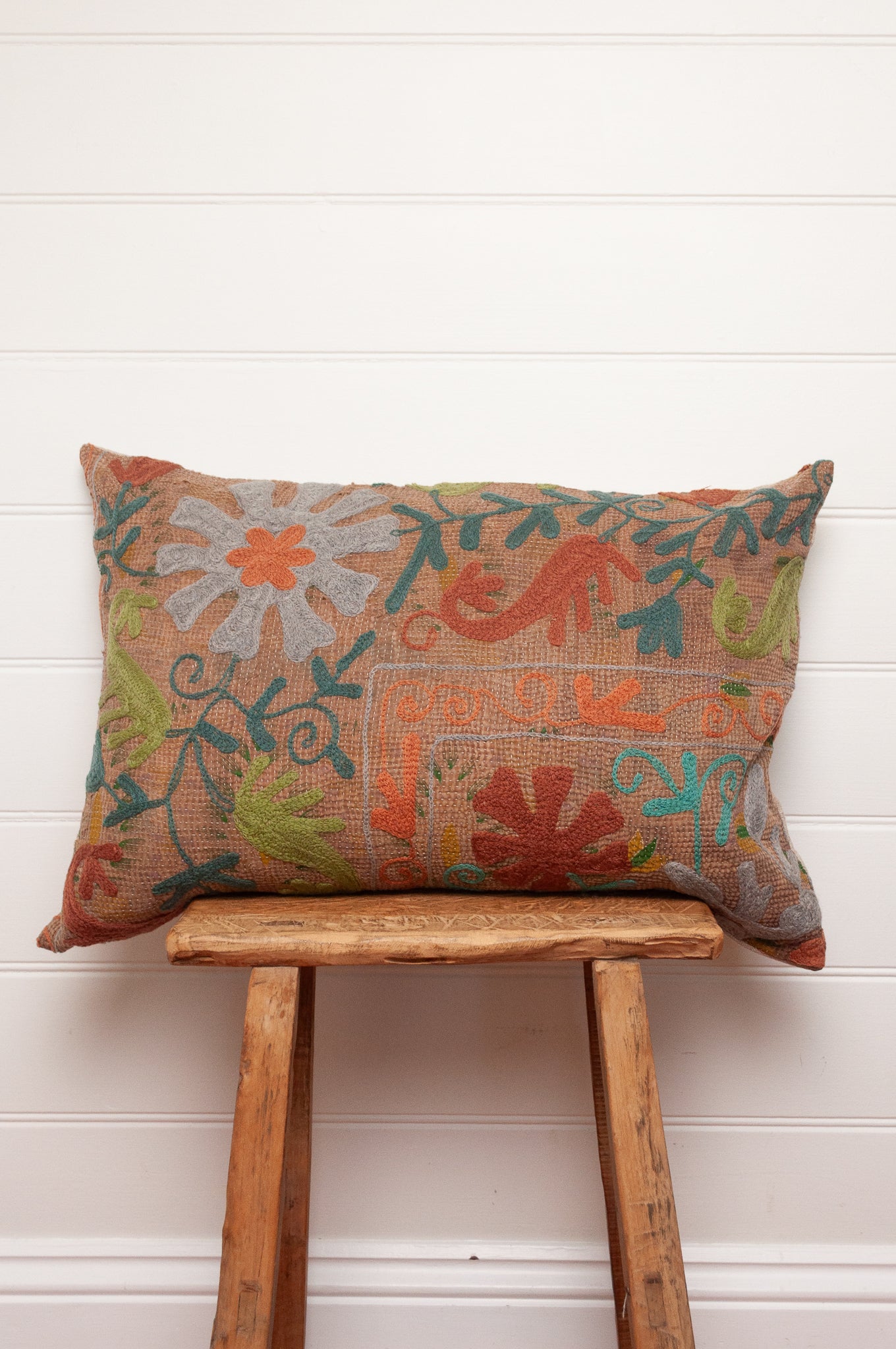 Suzani embroidered vintage kantha quilt cushion, floral design aqua, lime, rust and teal on sepia brown base.