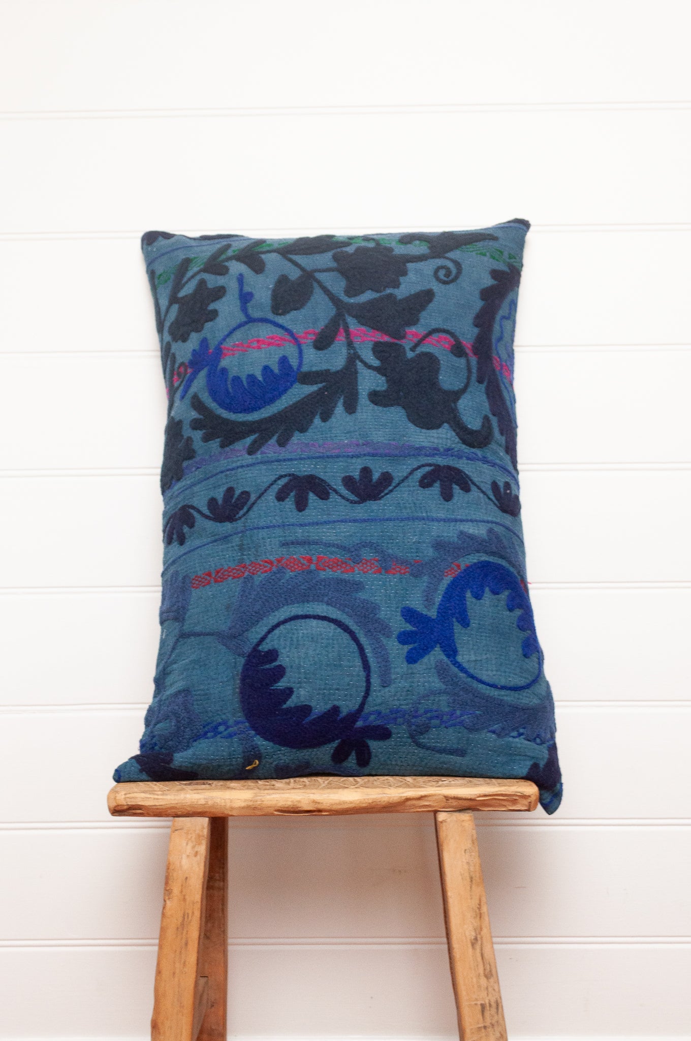 Suzani embroidered vintage indigo quilt, floral design in deep indigo and cobalt blue on indigo base with red highlights.