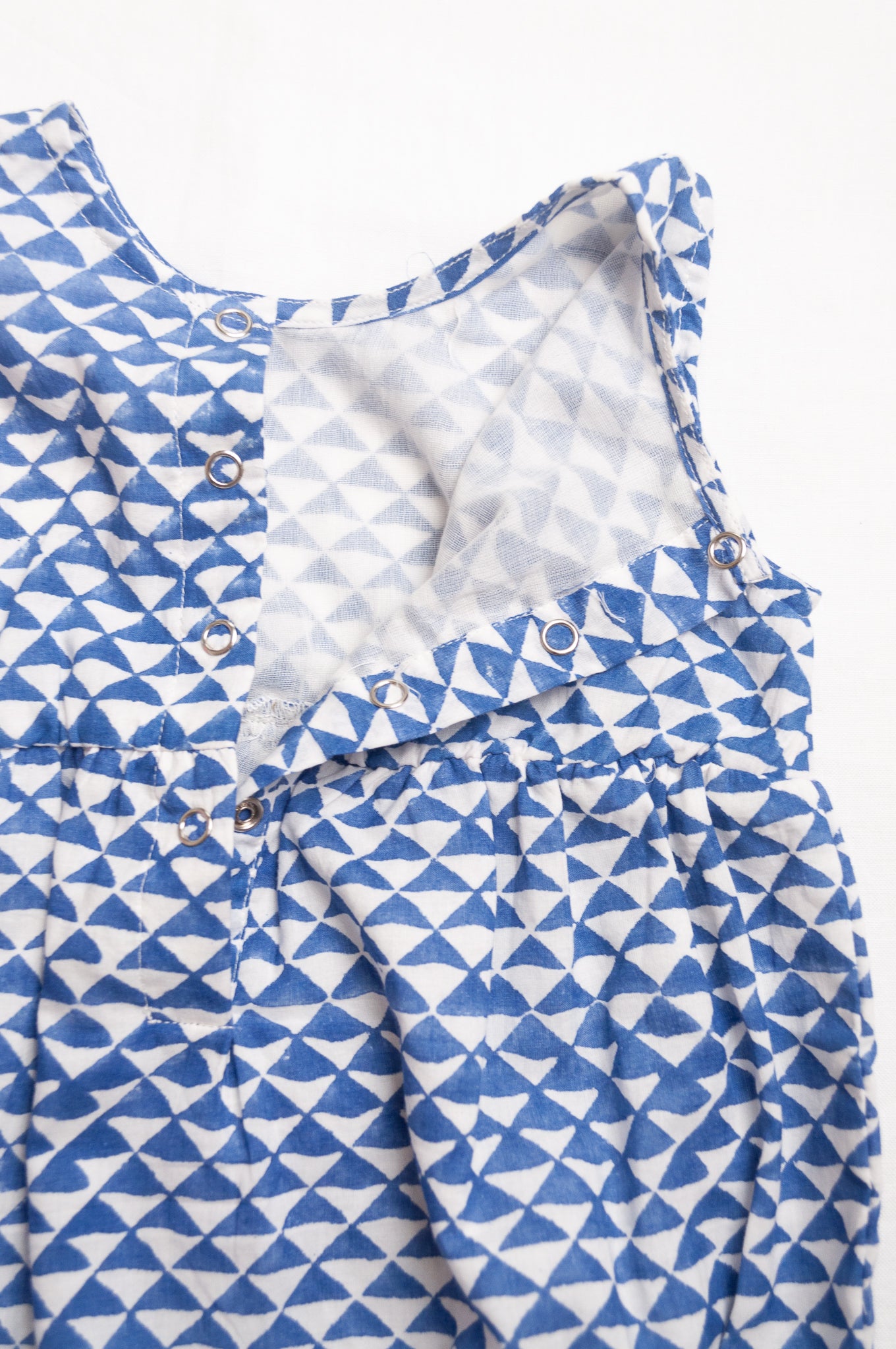 Juni Kids pure cotton blockprint baby romper in cobalt blue triangles on white.