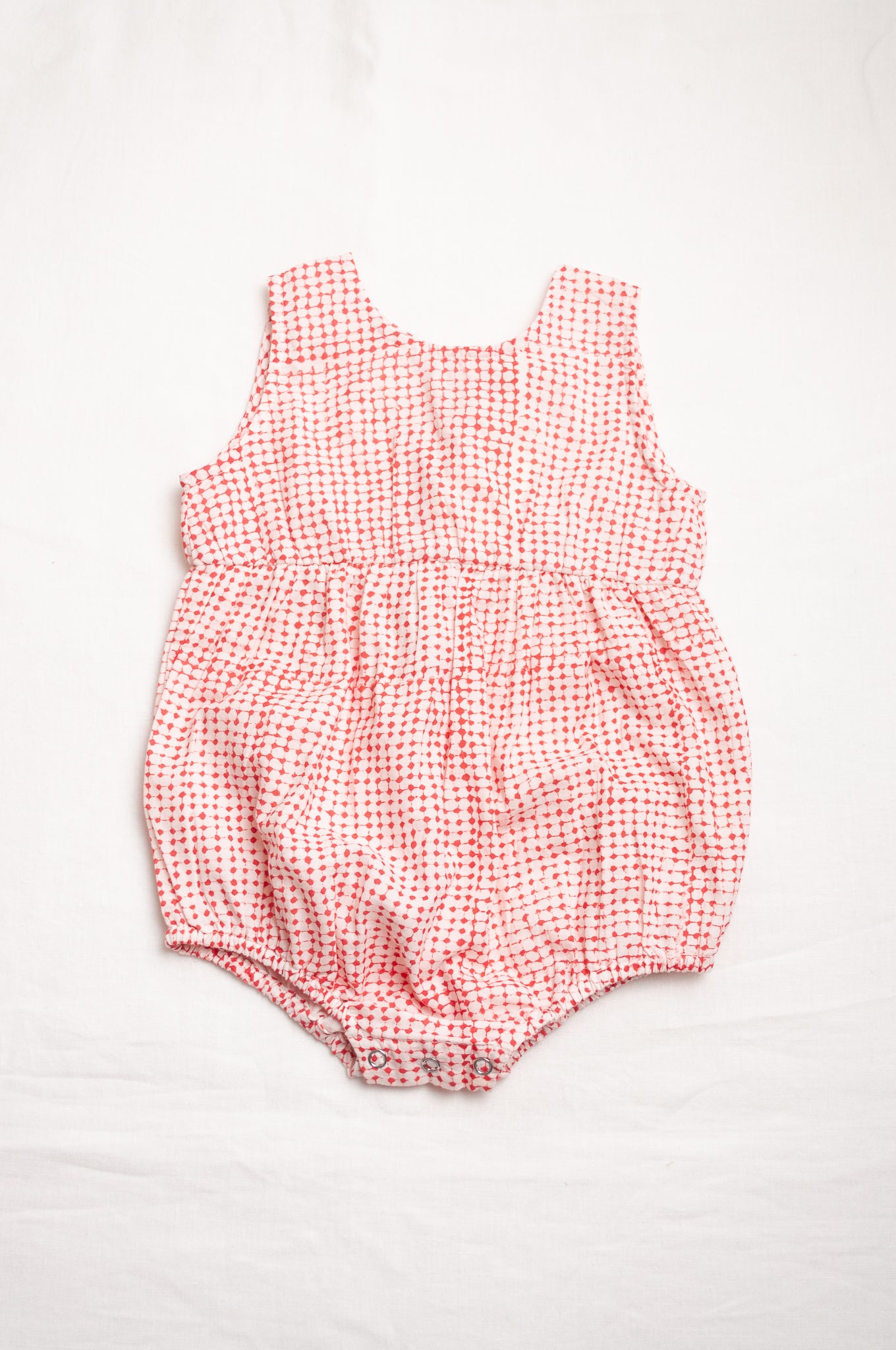 Juni Kids pure cotton blockprint baby romper in red dots on white.