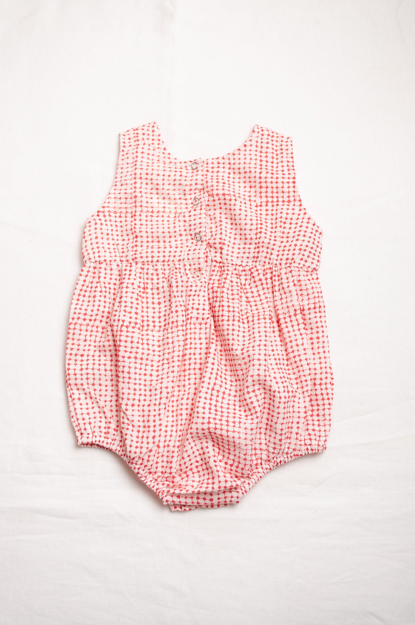 Juni Kids pure cotton blockprint baby romper in red dots on white.