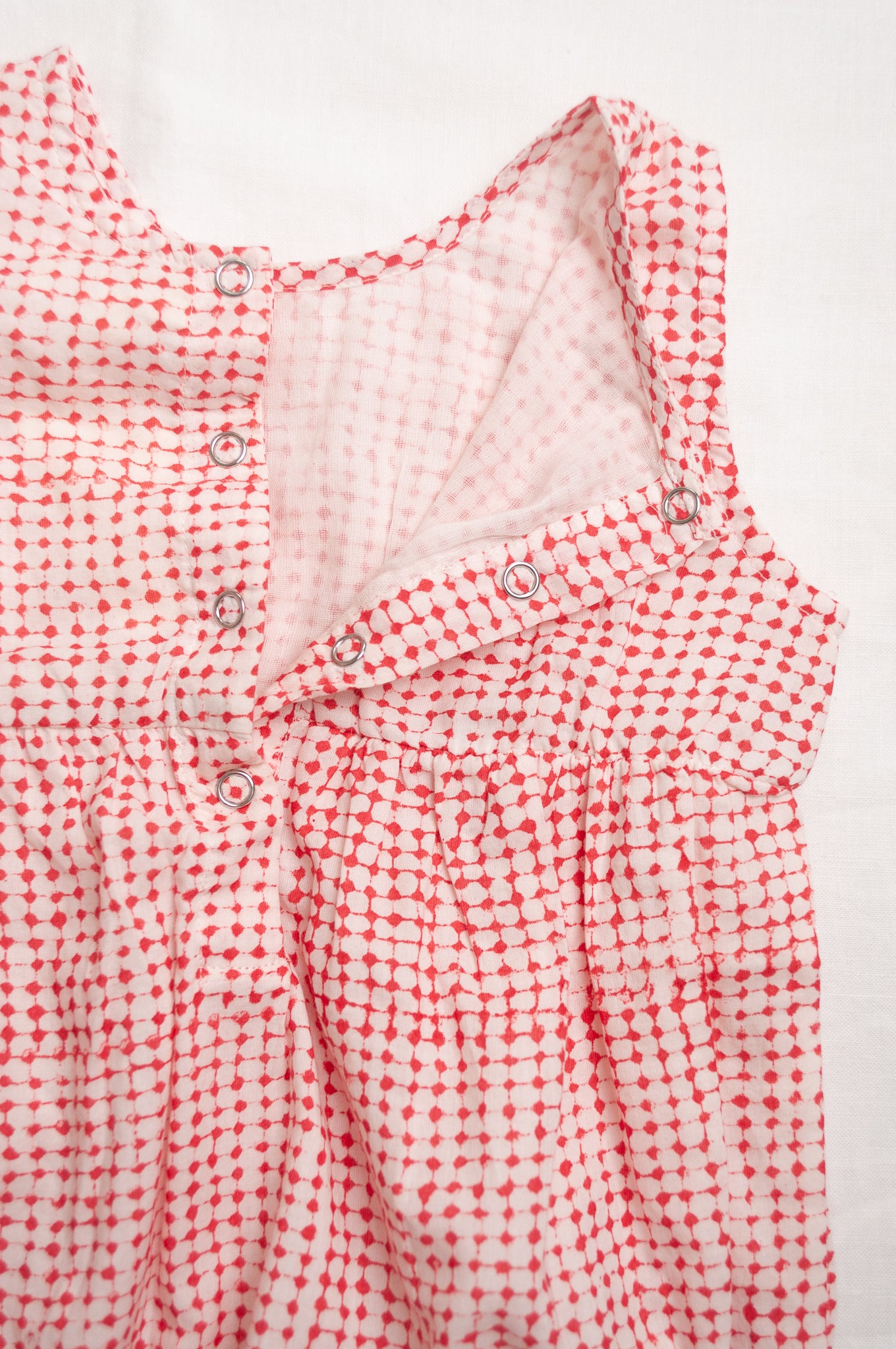 Juni Kids pure cotton blockprint baby romper in red dots on white.
