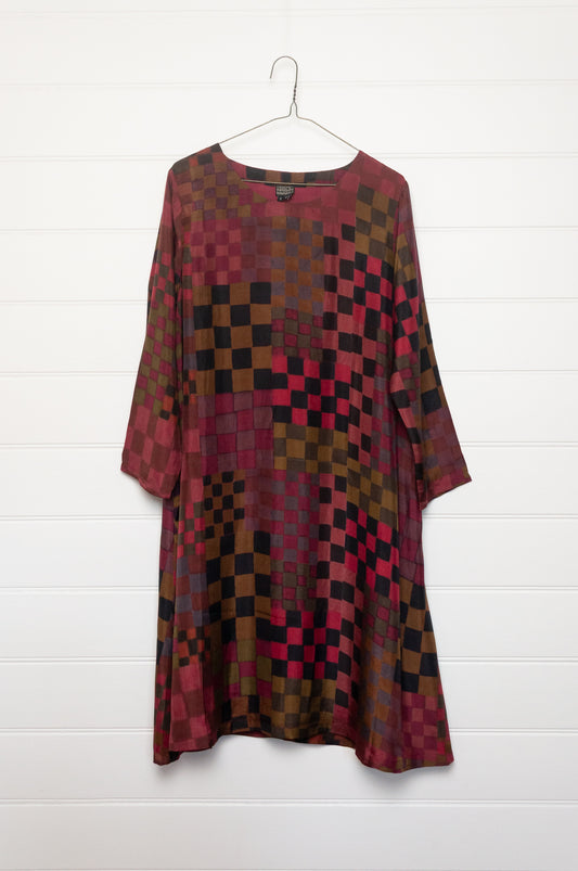 Neeru Kumar pure silk digital print A-line long-sleeved tunic dress with a geometric checkerboard pattern in shades of burgundy, magenta, brown, and black.