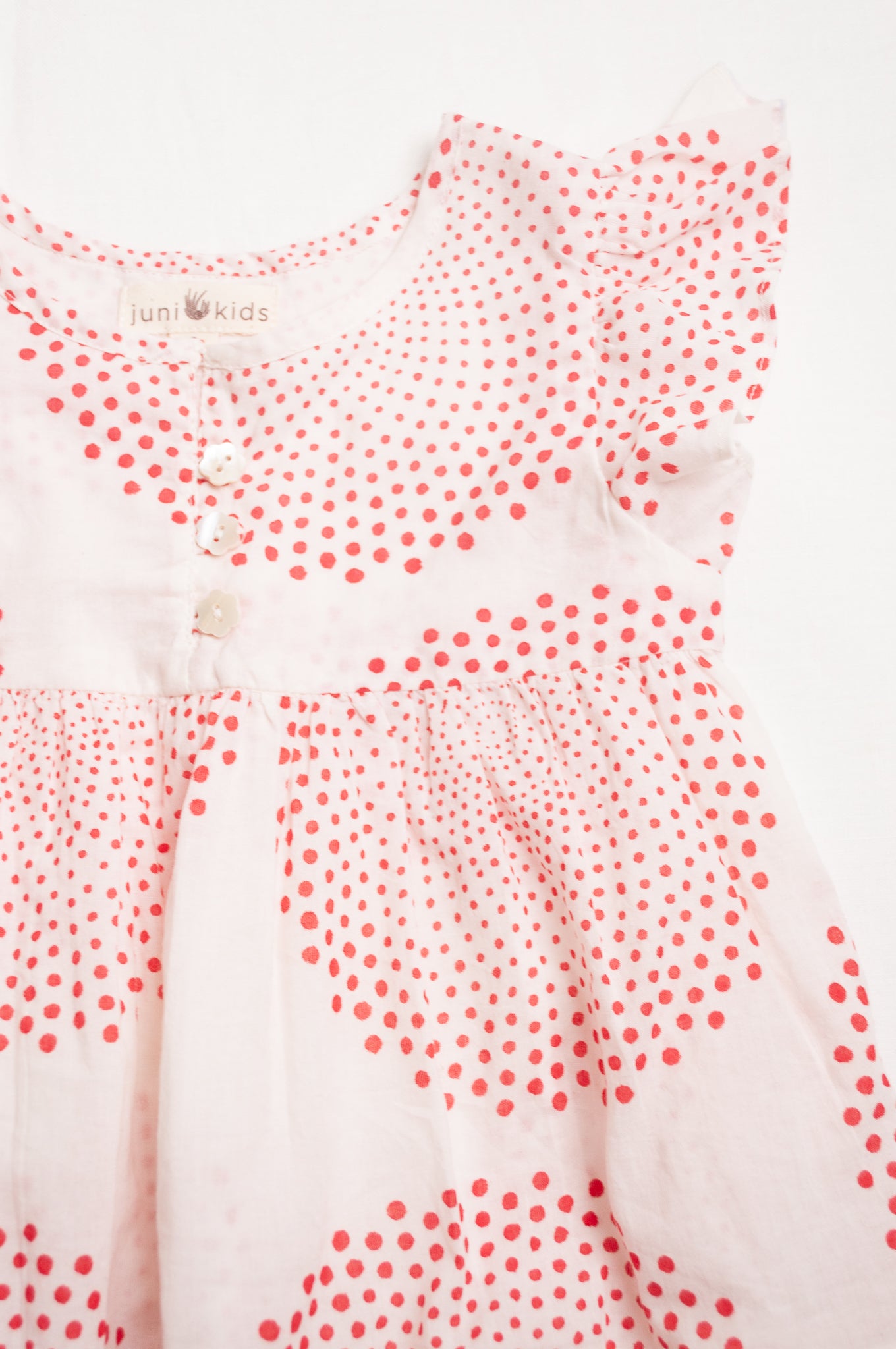 Juni Kids pure cotton blockprint baby dress in red circle dots on white.
