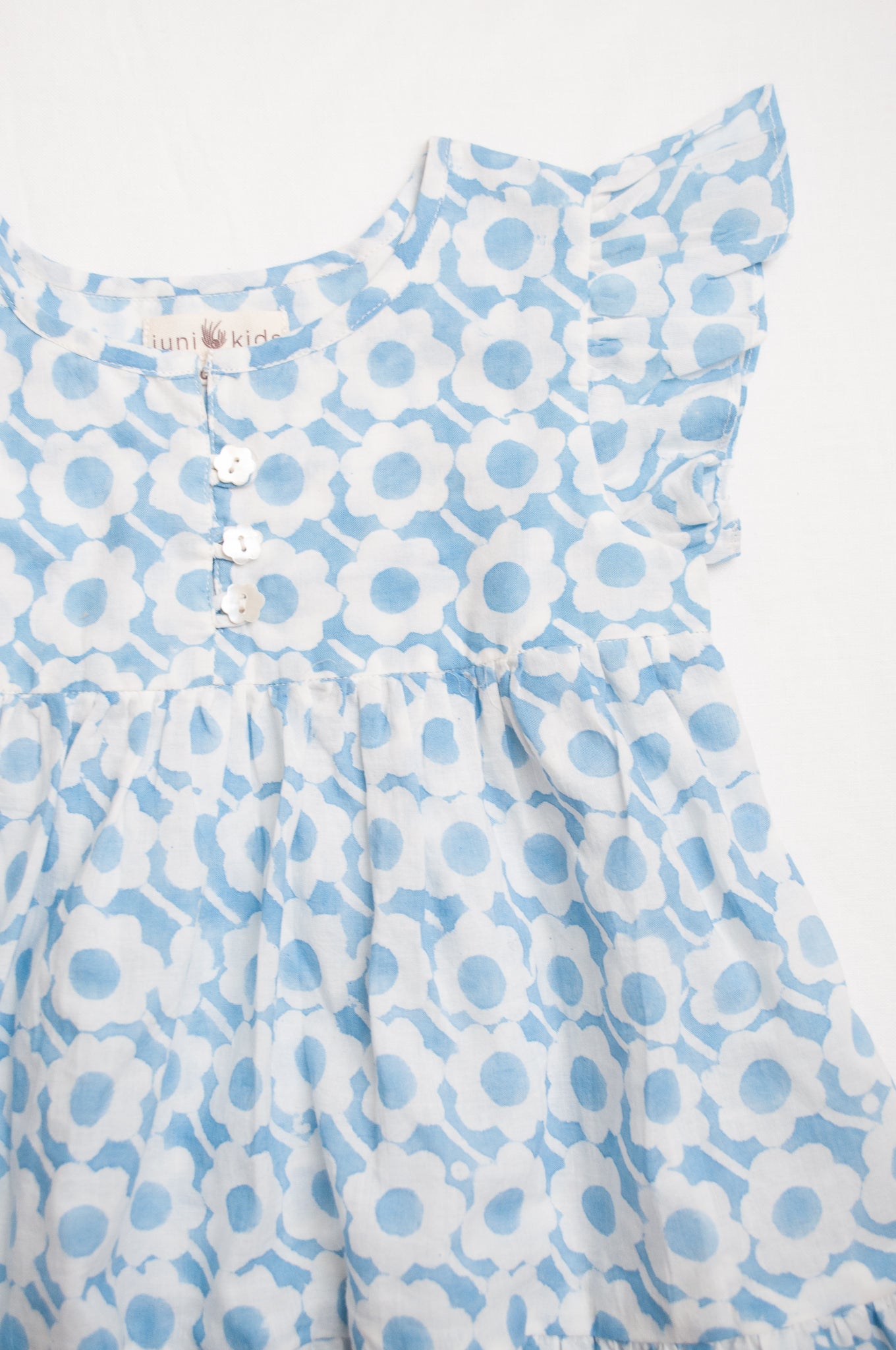 Juni Kids pure cotton blockprint baby dress in light blue and white floral pattern.