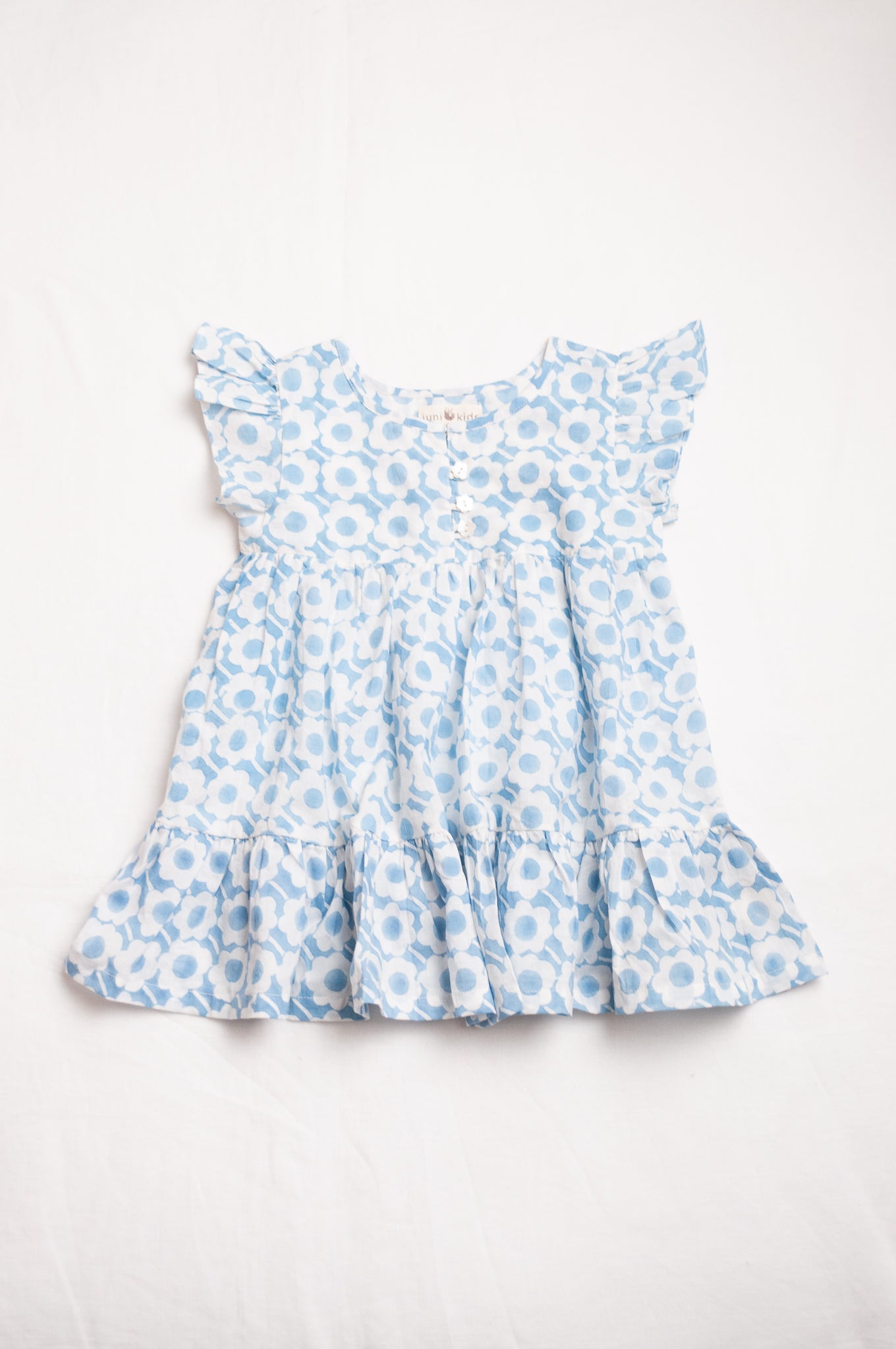 Juni Kids pure cotton blockprint baby dress in light blue and white floral pattern.