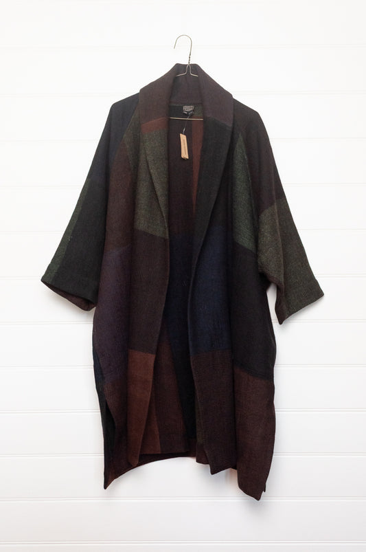 Neeru Kumar handwoven wool cardigan jacket coat in multicolor block pattern of charcoal, brown, aubergine purple, and black.
