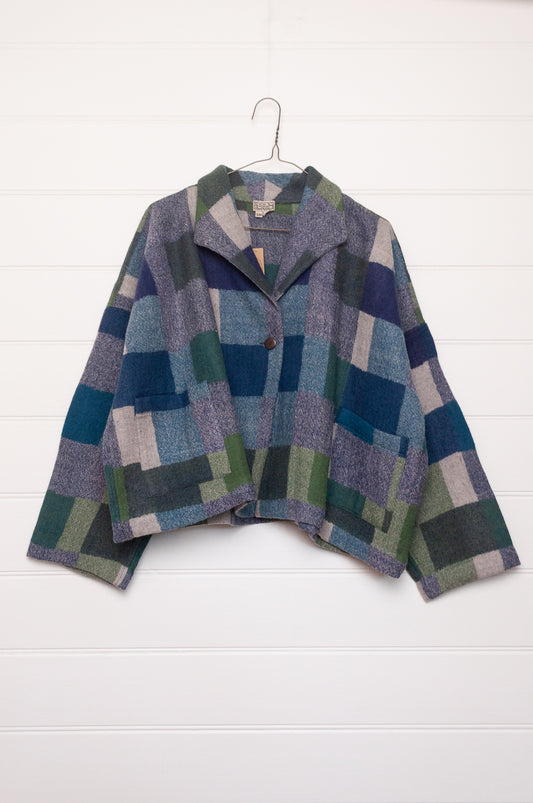 Neeru Kumar handwoven wool Coco jacket with a geometric blanket block pattern in shades of blue, green, gray, and beige