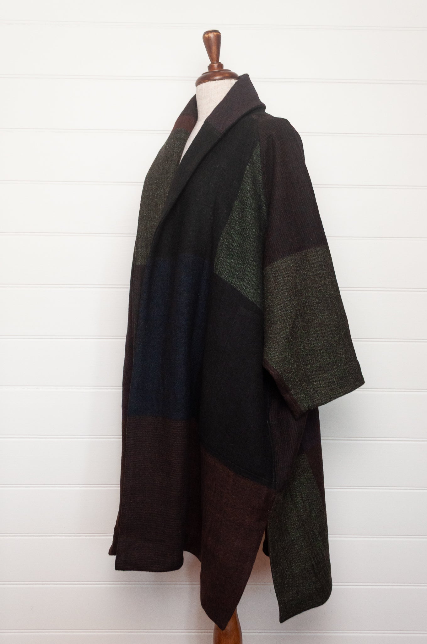 Neeru Kumar handwoven wool cardigan jacket coat in multicolor block pattern of charcoal, brown, aubergine purple, and black.